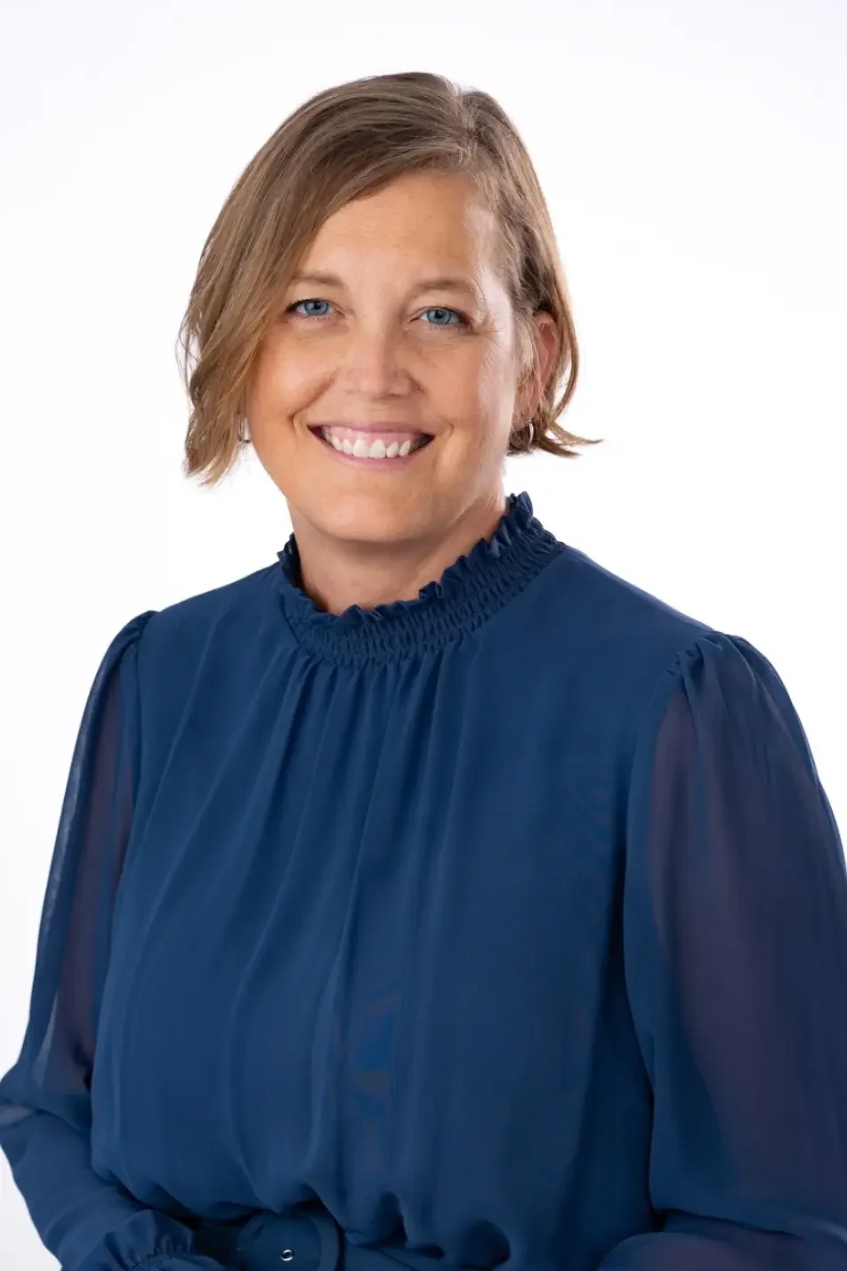 Ronda Lehn, FNP-C, smiling in a navy dress, nurse practitioner at a Ms.Medicine concierge practice in Cincinnati, Ohio