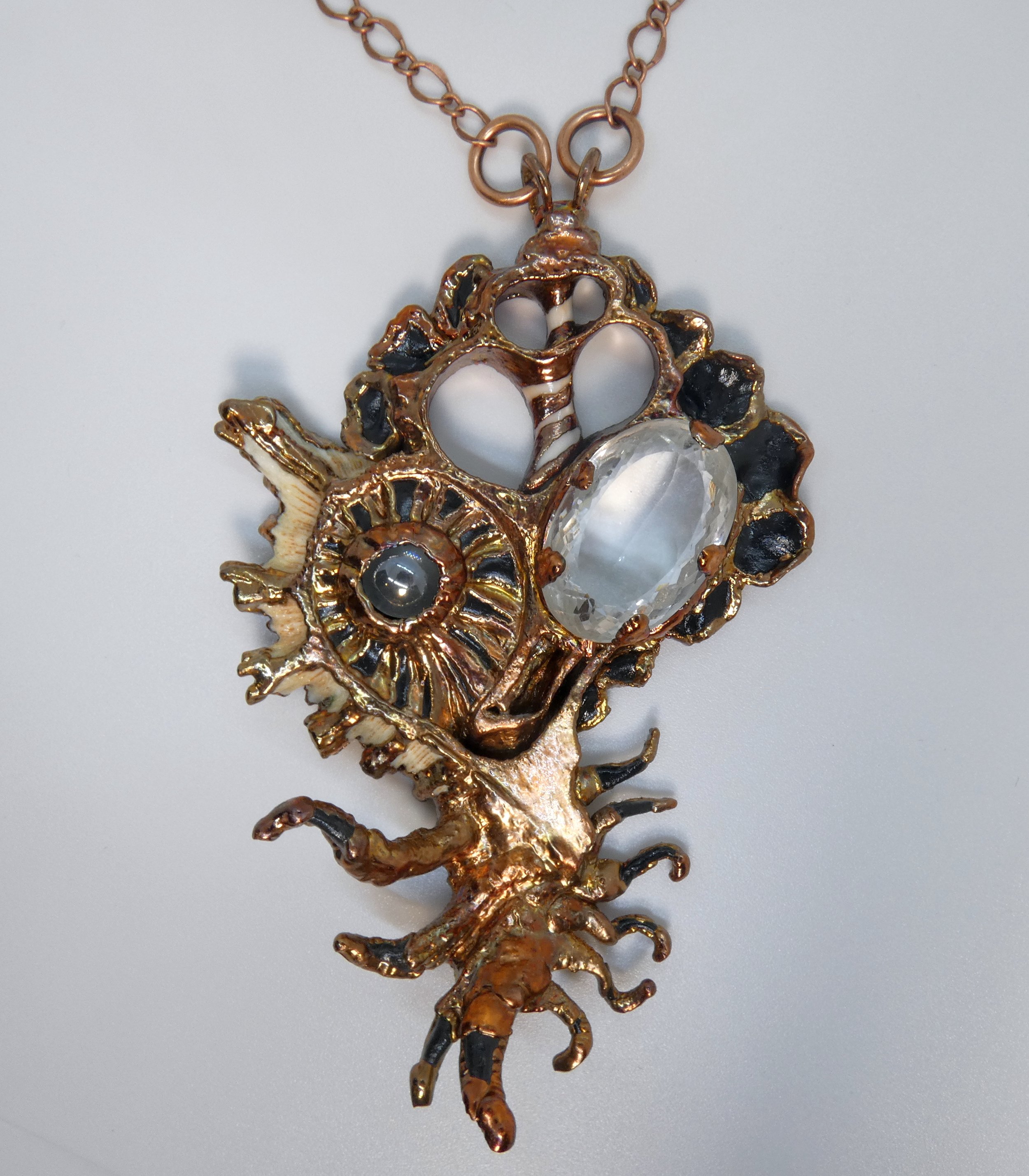 Symbiont 009 (Pendant): seashell slice, faceted quartz, moving glass marble, chain, epoxy clay, electroformed in copper. Available $750.