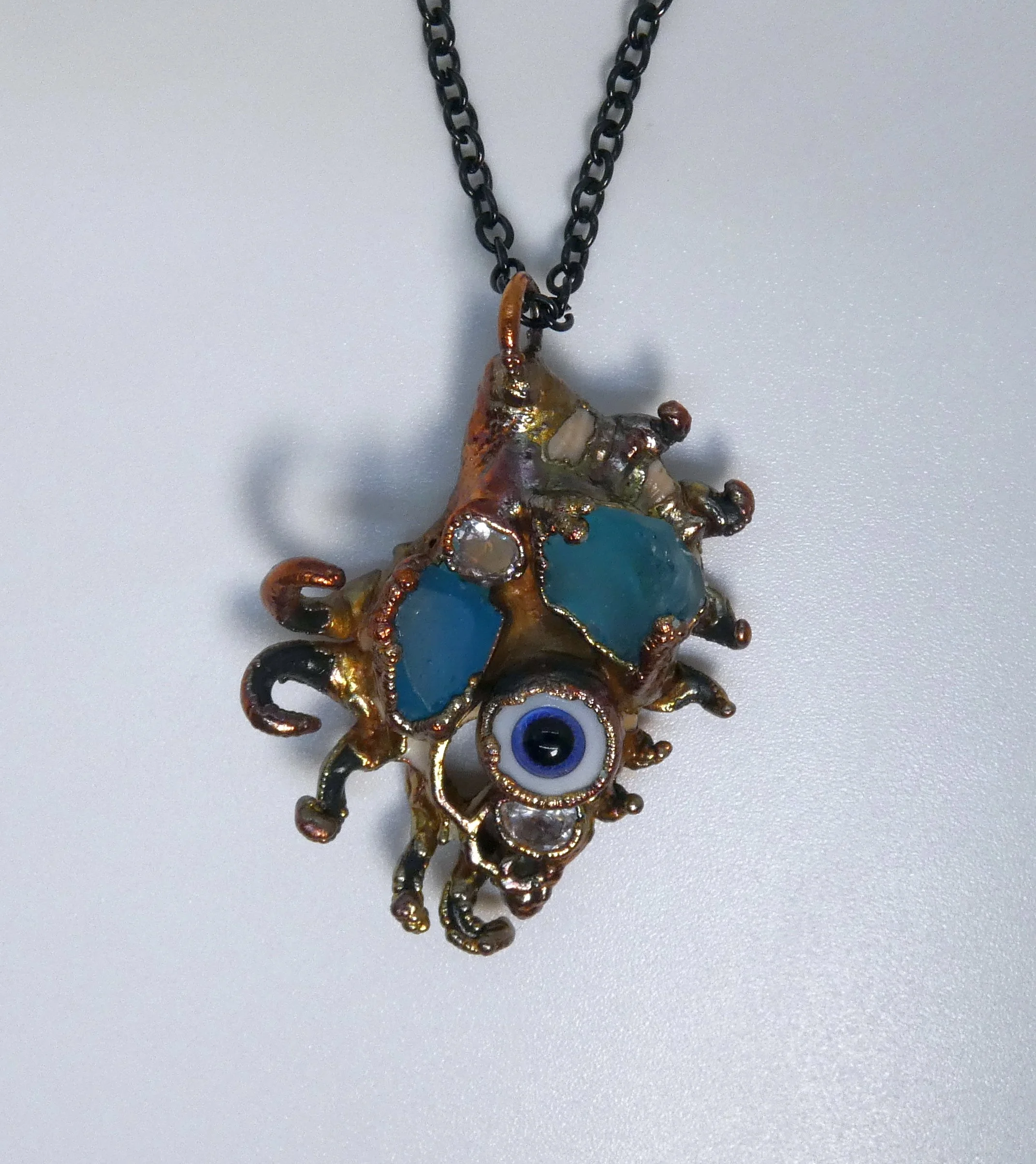Symbiont 025 (Pendant): seashell slice, vintage Lauscha glass doll eye, glass, rhinestones, epoxy clay, electroformed in copper. 2” H x 1.75” W. For my husband :)