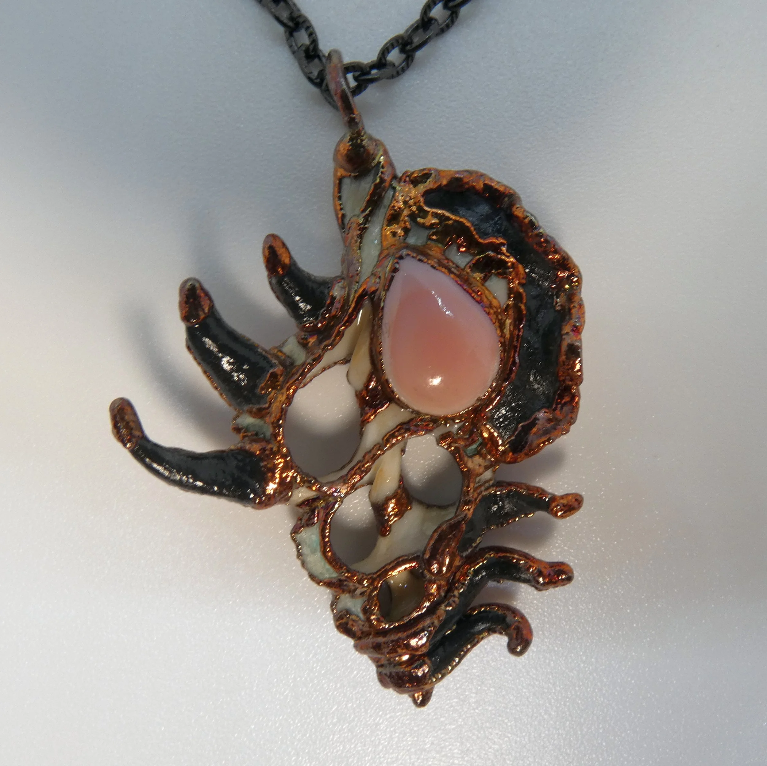 Symbiont 016 (Pendant): seashell slice, mother of pearl, epoxy clay, electroformed in copper. 2.25” H x 1.5” W. Available $200.