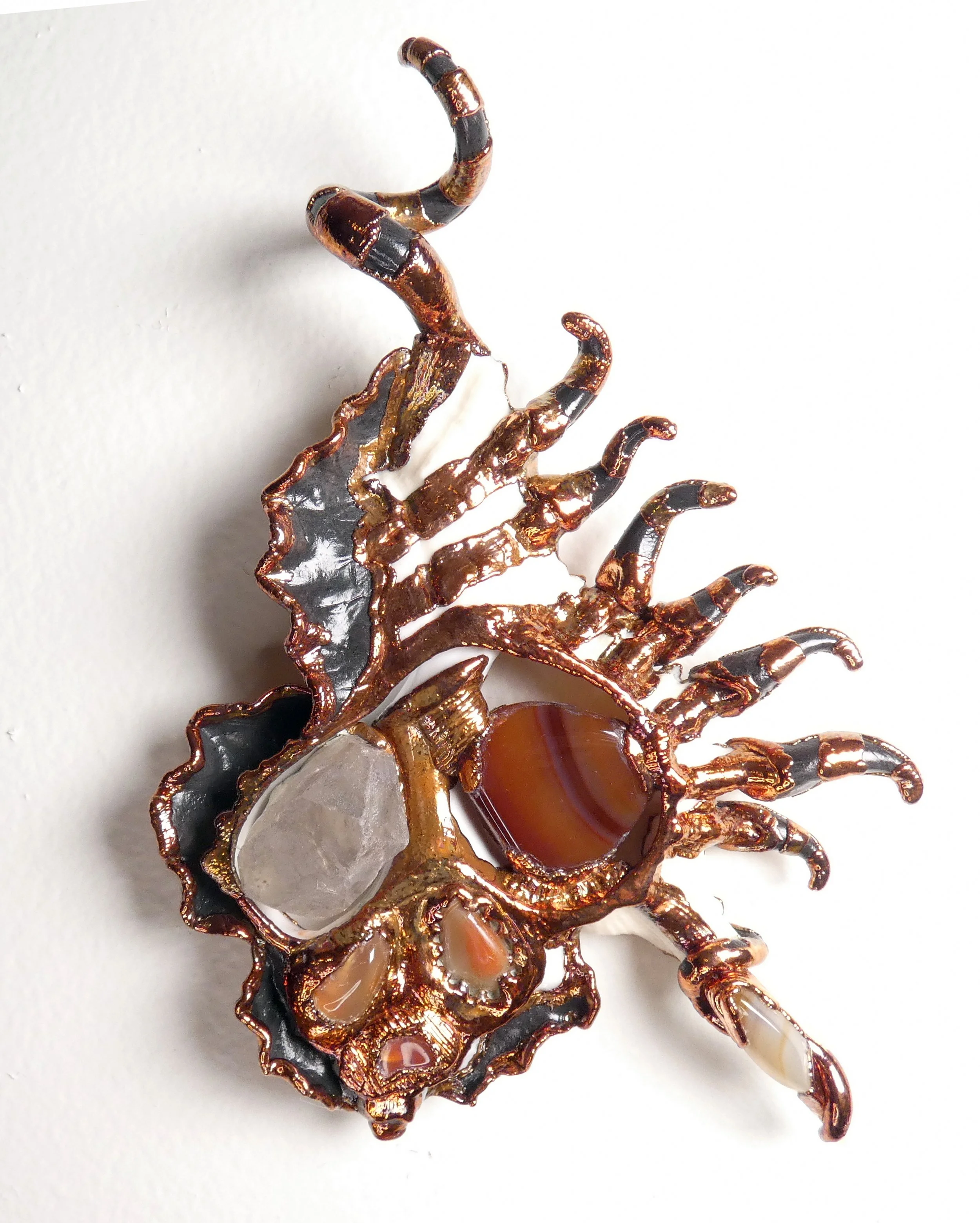 Symbiont 048 (Wall sculpture): seashell slice, quartz crystal, banded agates, epoxy clay, electroformed copper. 6" H x 5" W x 2” D. In private collection.