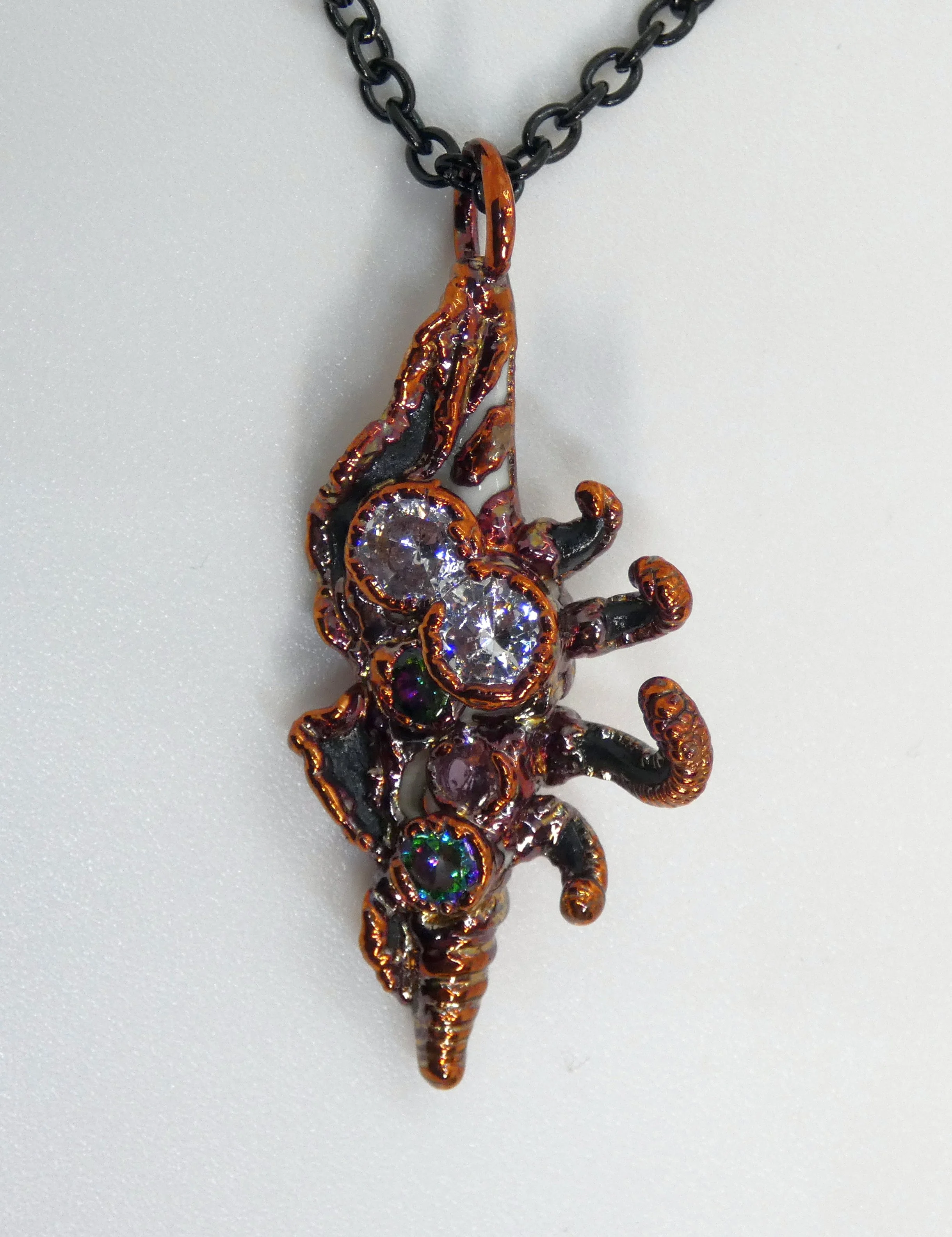 Symbiont 041 (Pendant): seashell slice, rhinestones, epoxy clay, electroformed copper. 2" H x 1" W. In private collection.