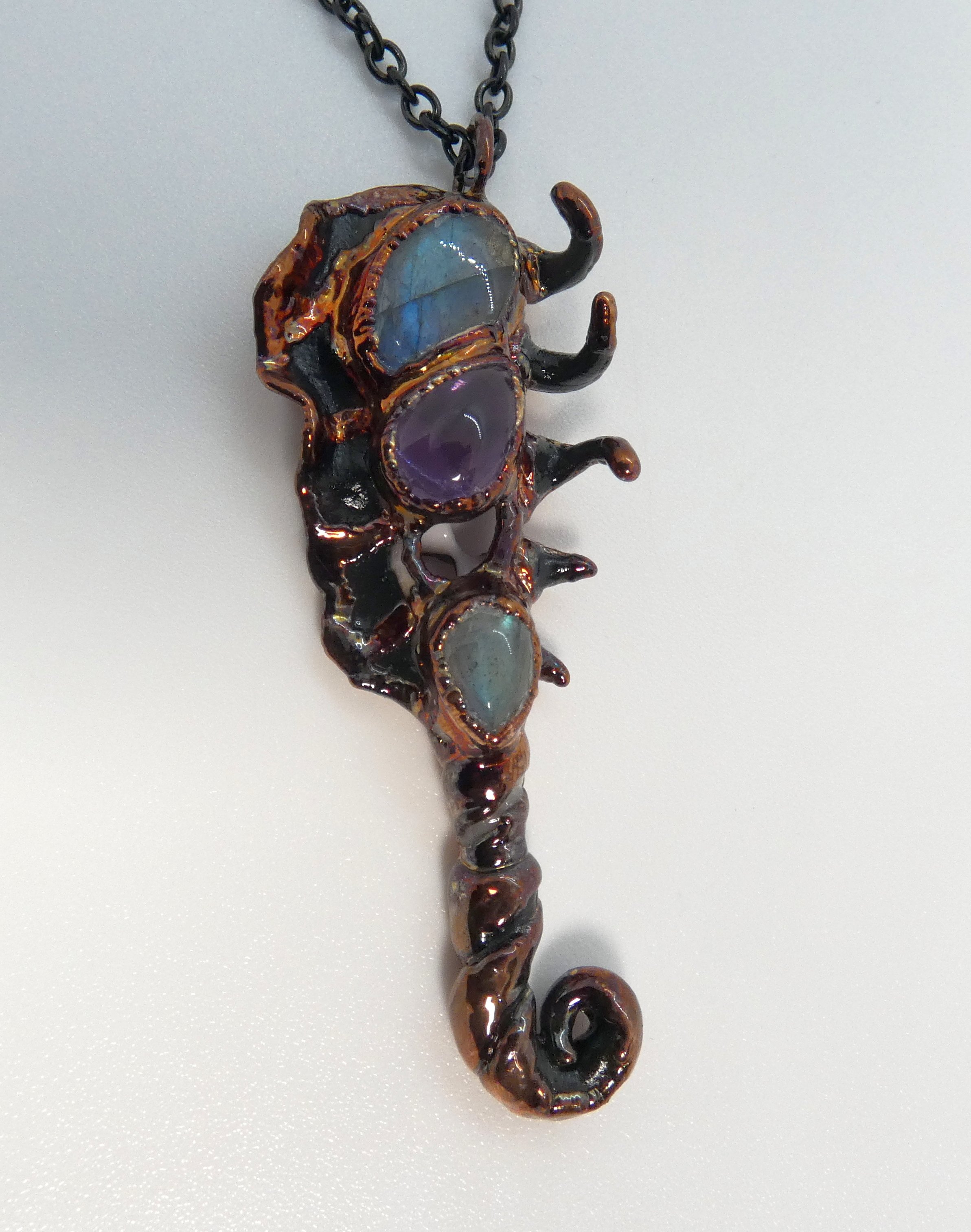 Symbiont 042 (Pendant): seashell slice, labradorite, amethyst, epoxy clay, electroformed copper. 3" H x 1" W. In private collection.