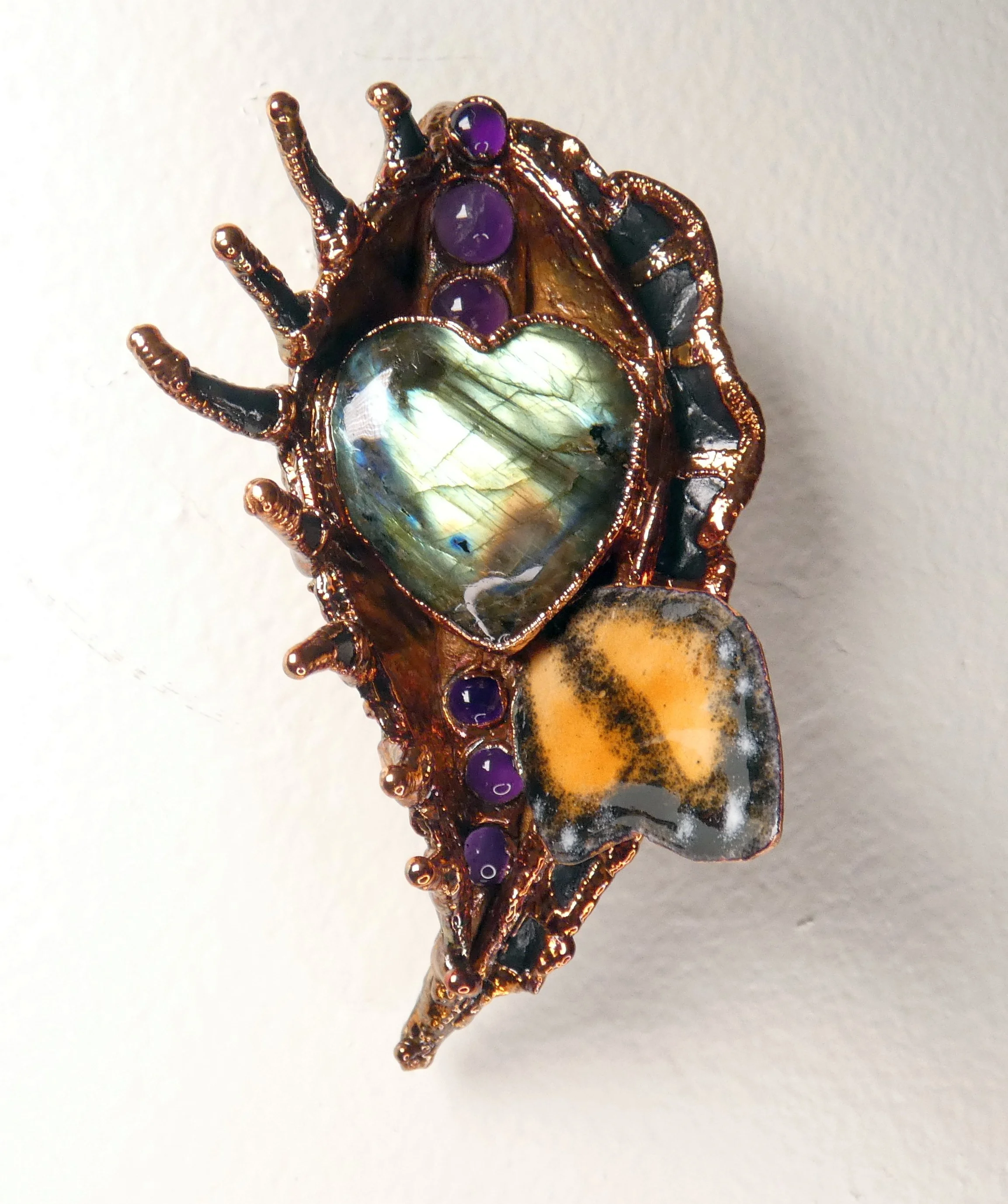 Symbiont 051 (Wall sculpture): milkweed pod, enameled copper monarch, labradorite, amethyst, epoxy clay, electroformed copper. 4" H x 2.5" W x 2.5” D. In private collection.
