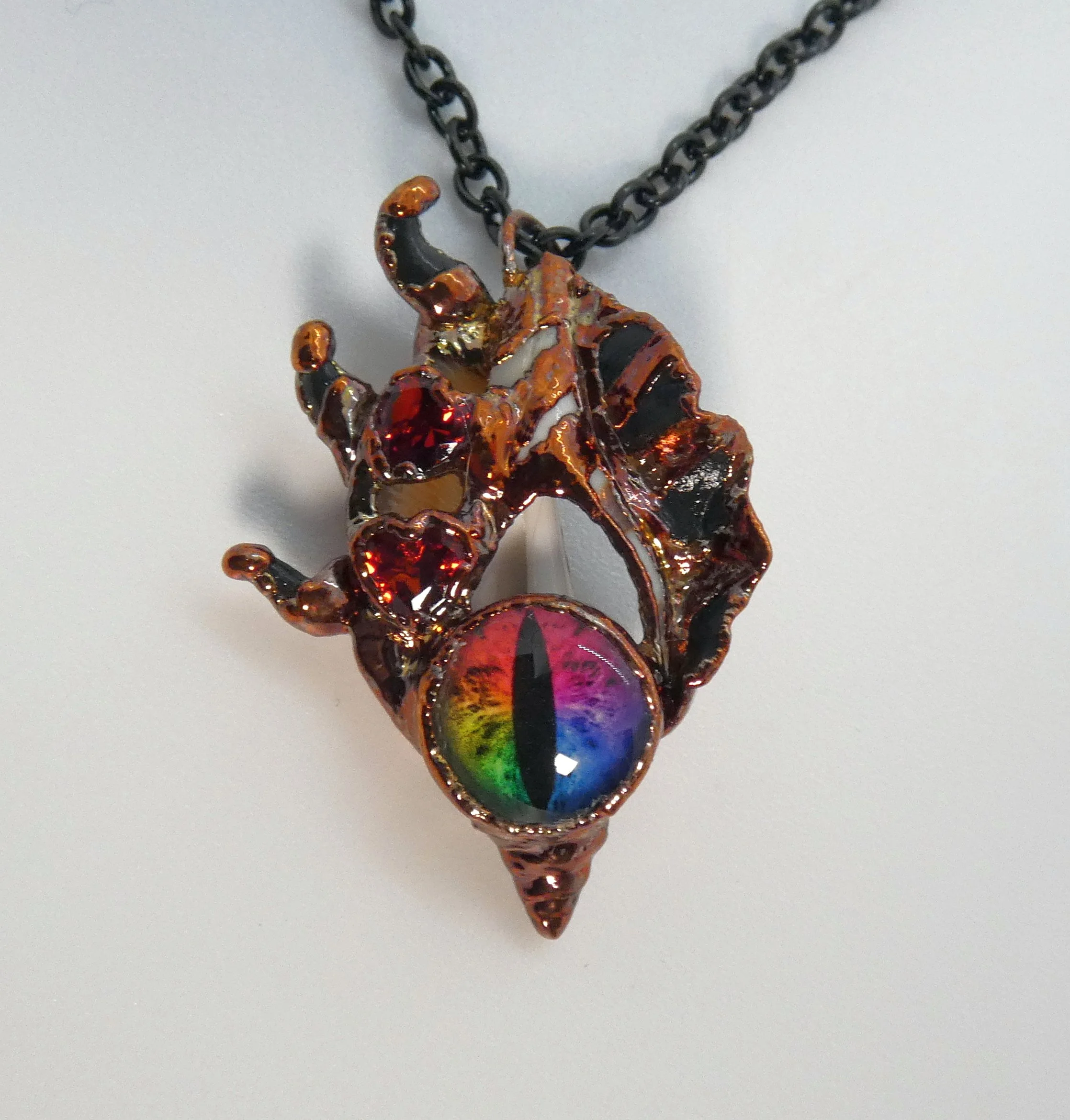 Symbiont 040 (Pendant): seashell slice, glass dragon eye, rhinestones, epoxy clay, electroformed copper. 1.75” H x 1” W. Available $150.