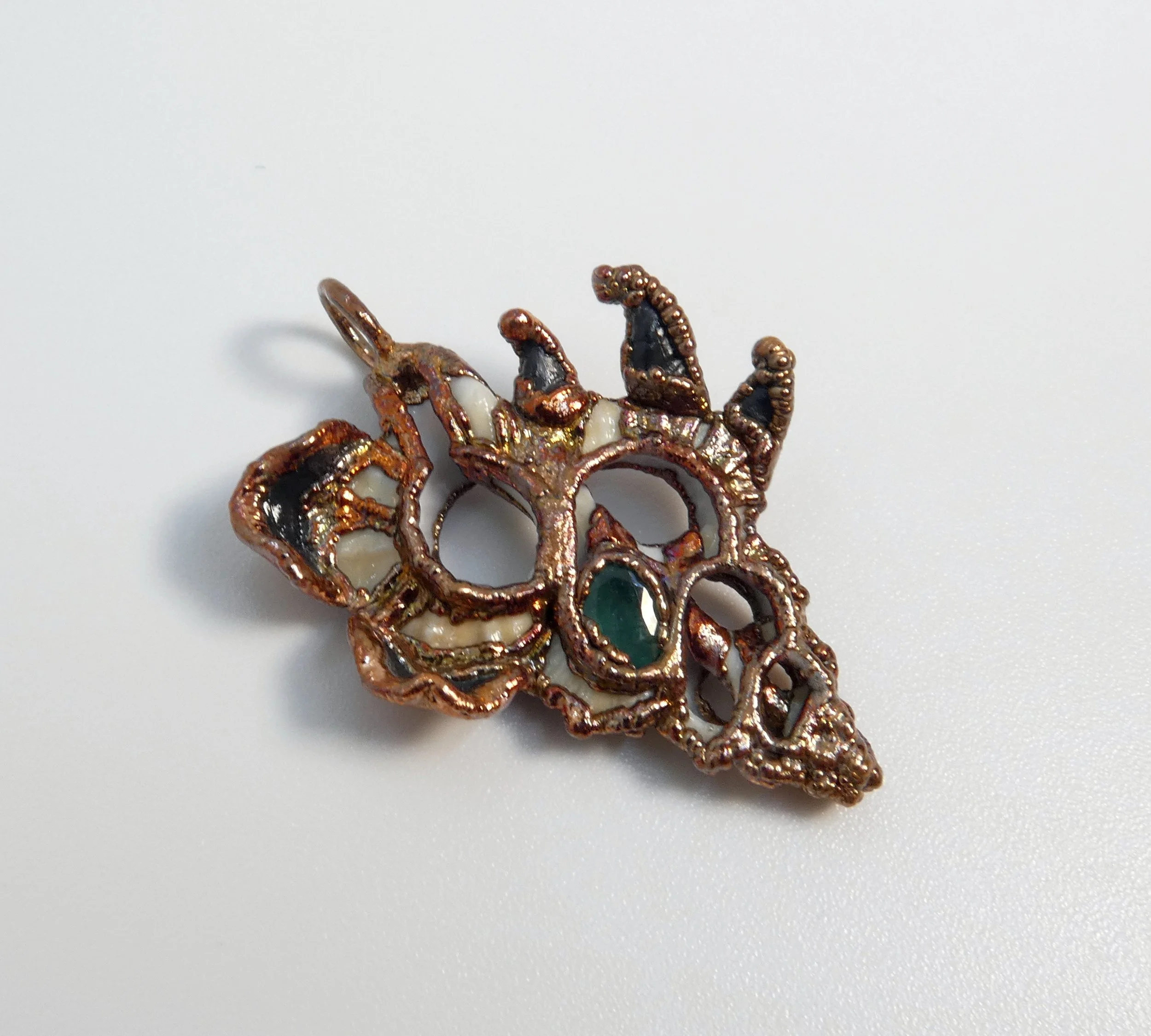 Symbiont 014 (Pendant): seashell slice, faceted emerald, epoxy clay, electroformed in copper. 1.5”H x 1” W. In private collection.
