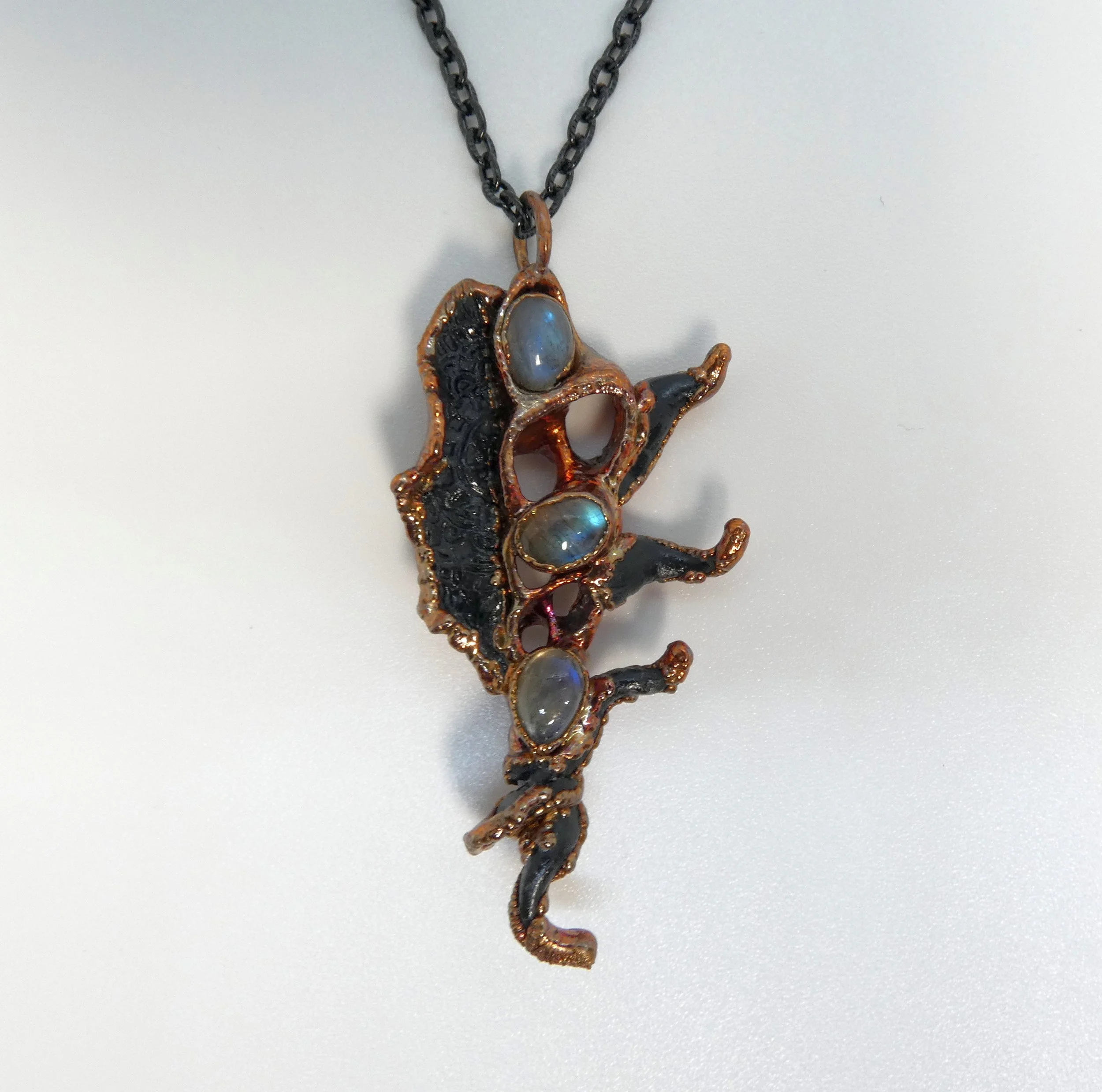 Symbiont 015 (Pendant): seashell slice, labradorite, epoxy clay, electroformed in copper. 3” H x 1.5” W. In private collection.