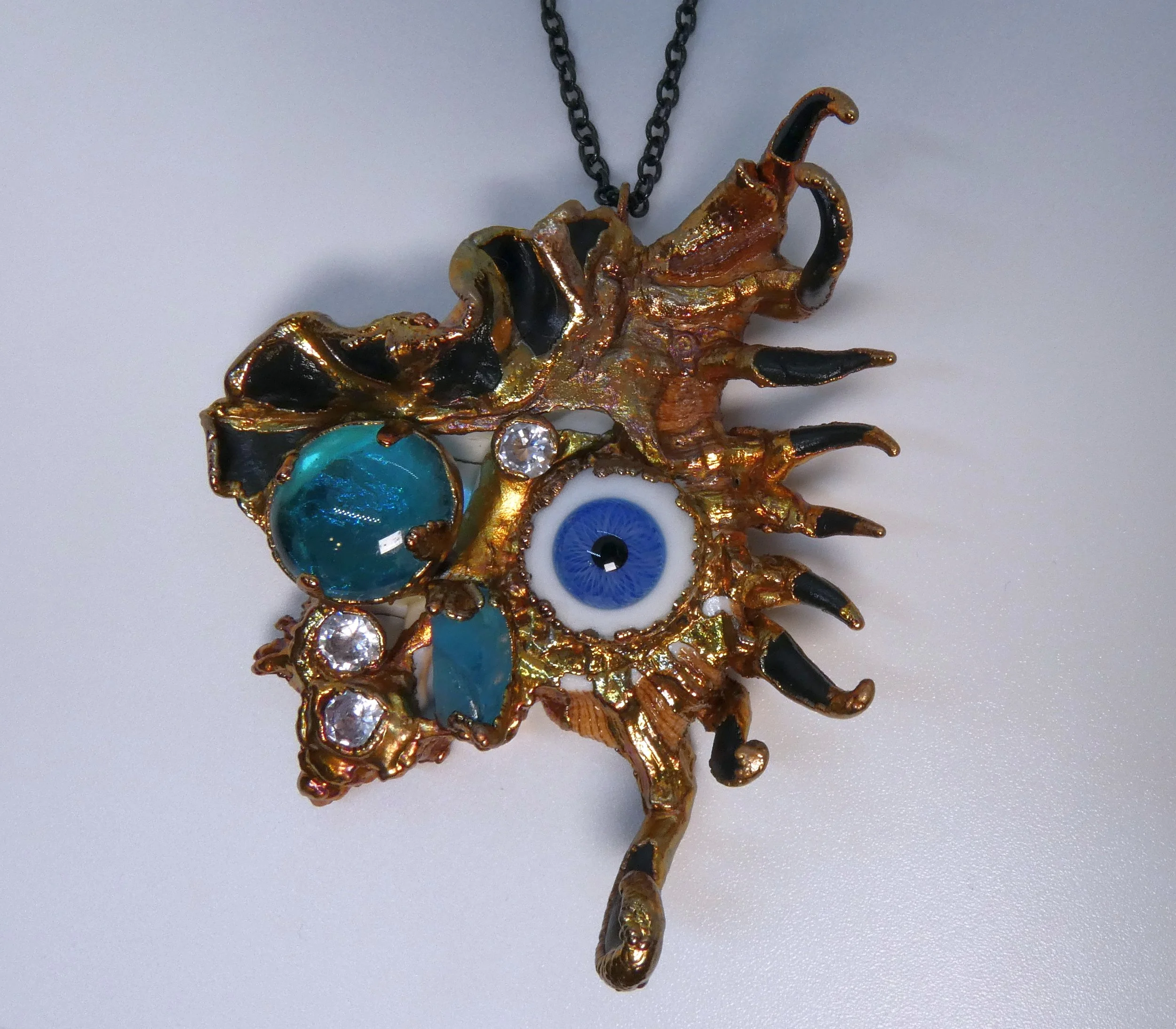 Symbiont 026 (Pendant): seashell slice, vintage Lauscha glass doll eye, glass, rhinestones, epoxy clay, electroformed in copper. 4” H x 3” W. For me :)