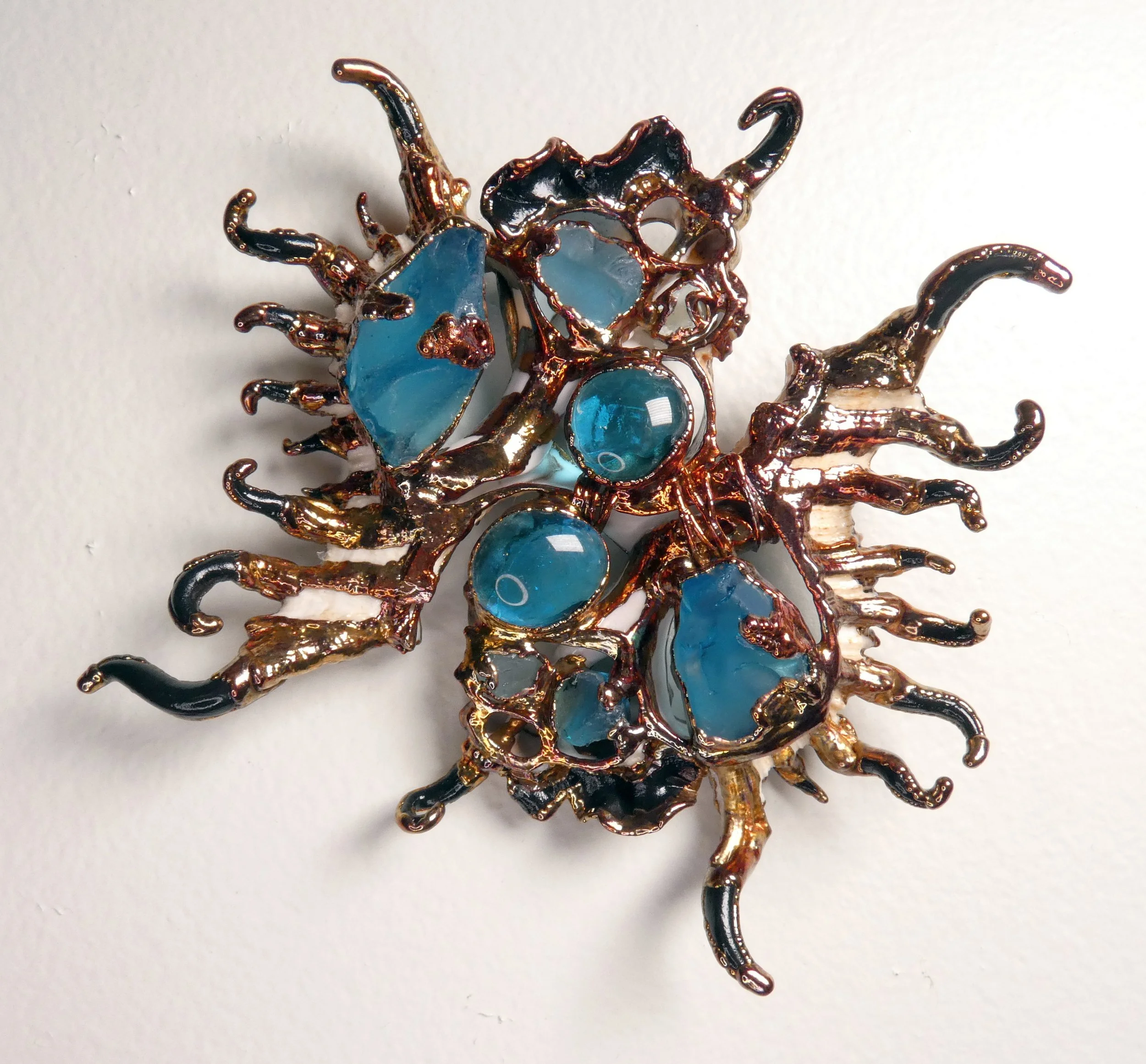 Symbiont 034 (Wall sculpture with keyhole slot): seashell slices, copper wire, glass, epoxy clay, electroformed in copper. 5” H x 5” W x 2” D. Available $1000.