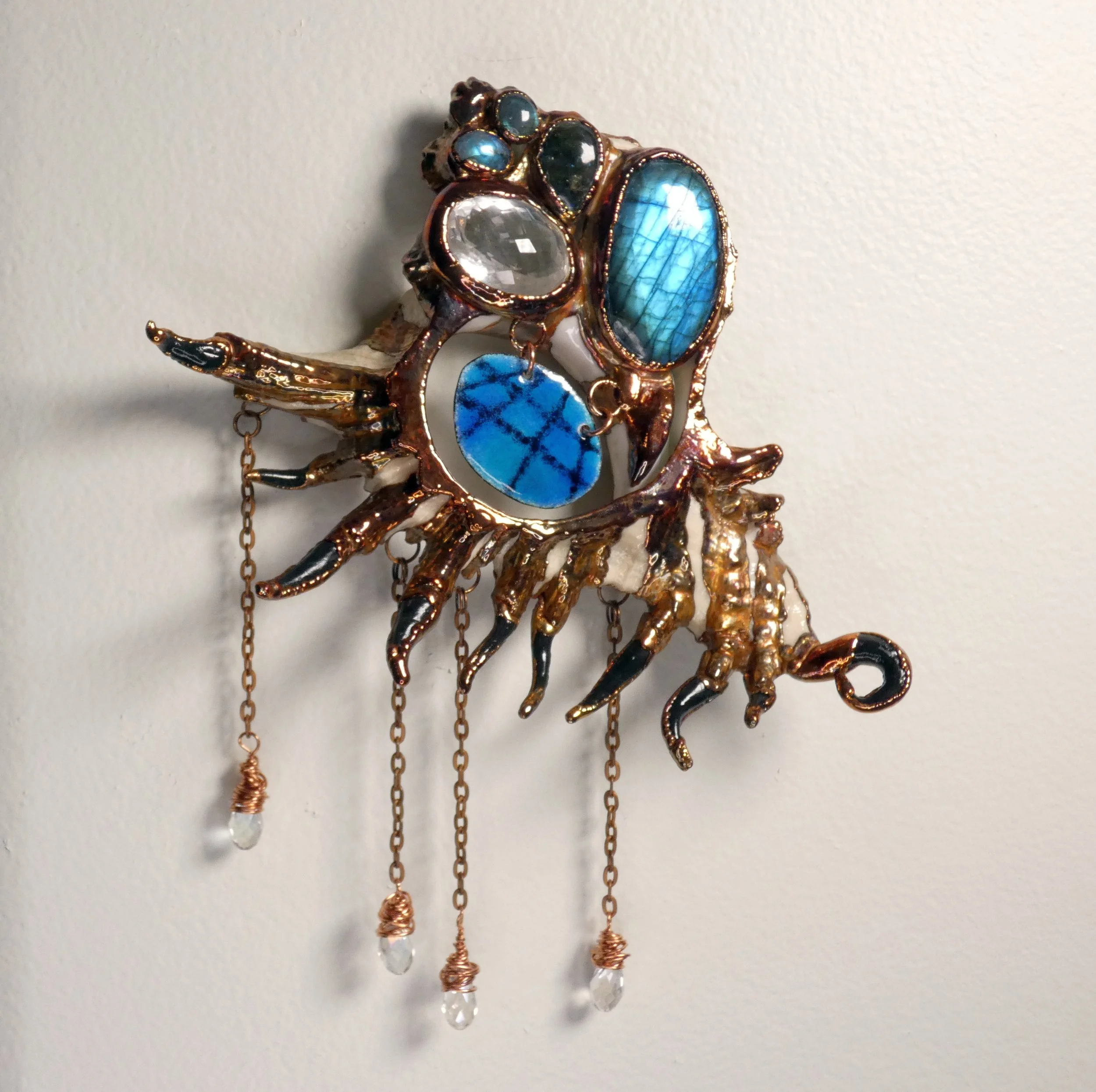 Symbiont 032 (Wall sculpture with keyhole slot): seashell slice, labradorite, faceted quartz, epoxy clay, electroformed in copper with enameled copper accent, copper wire and chain, and faceted glass beads. Available $1200.