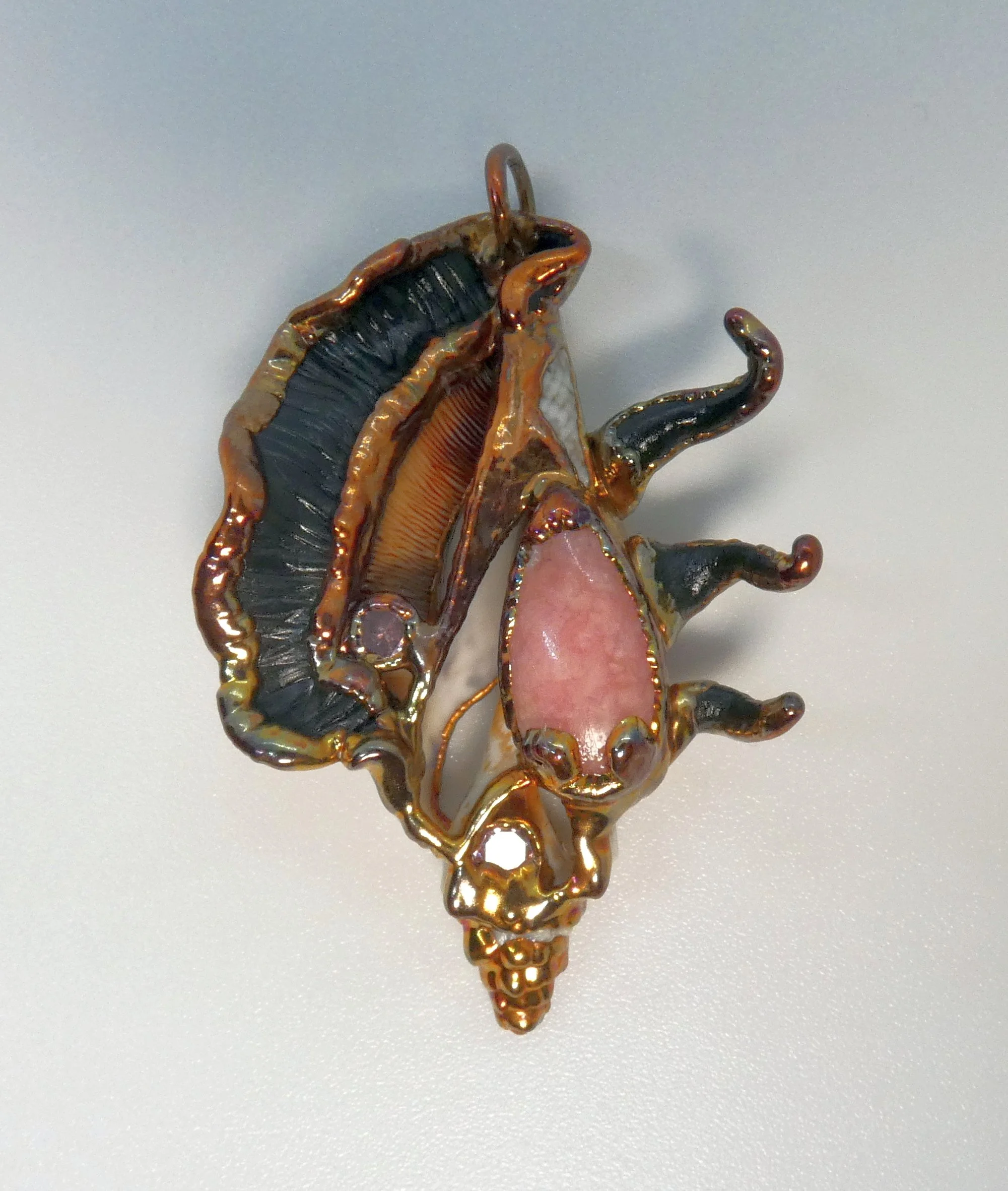 Symbiont 028 (Pendant): seashell slice, rhodochrosite, rhinestones, epoxy clay, electroformed in copper. 2” H x 1.5” W. Donation to Christkindl Markt Silent Auction, Canton Museum of Art, 2024