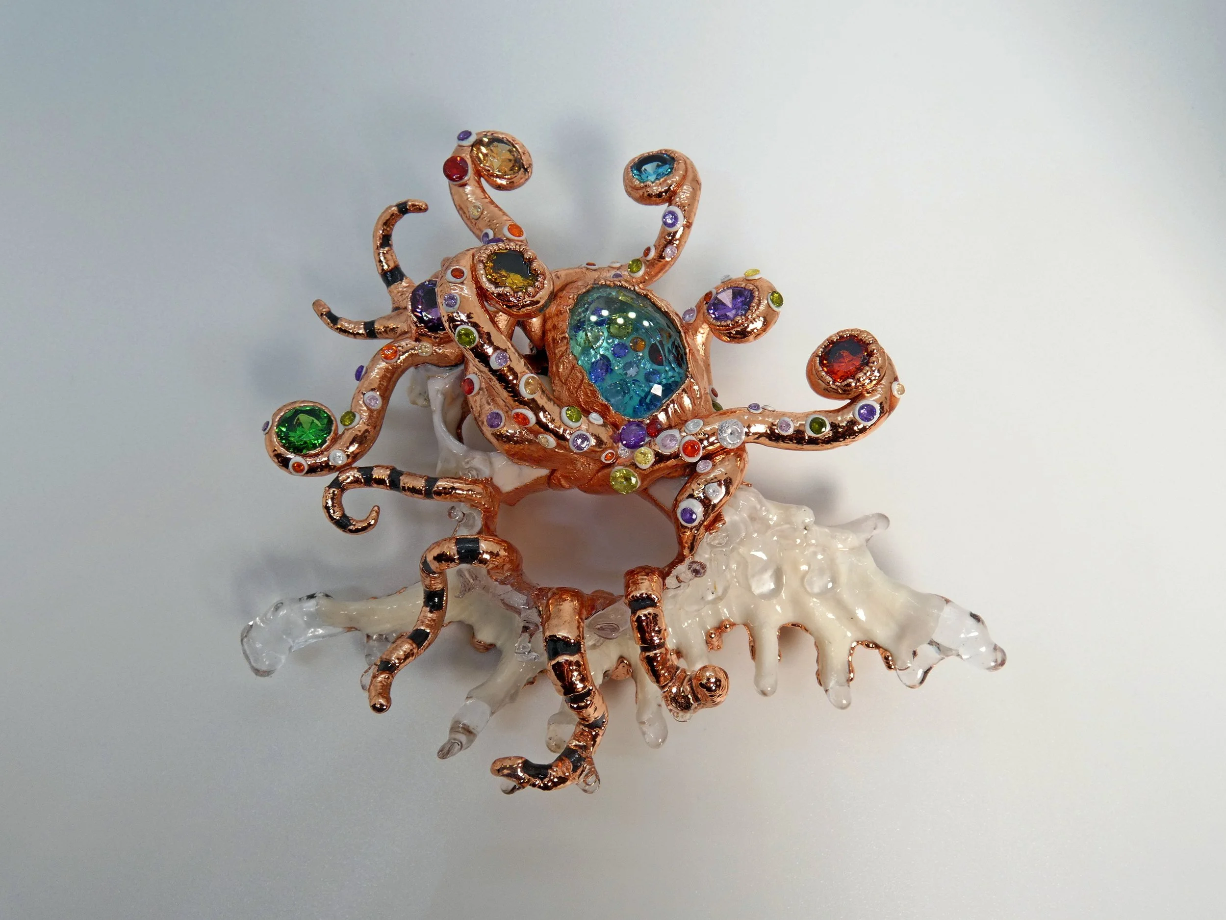 Emergence 001 (Out of the Water): seashell slice, faceted quartz, rhinestones, epoxy clay, UV resin, trapped liquid, electroformed copper. 5" H x 6" W x 2" D wall sculpture with keyhole slot. Not for sale.
