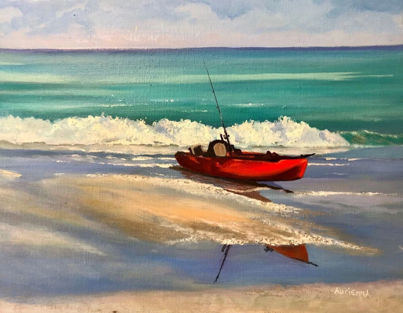 red canoe on beach by ocean
