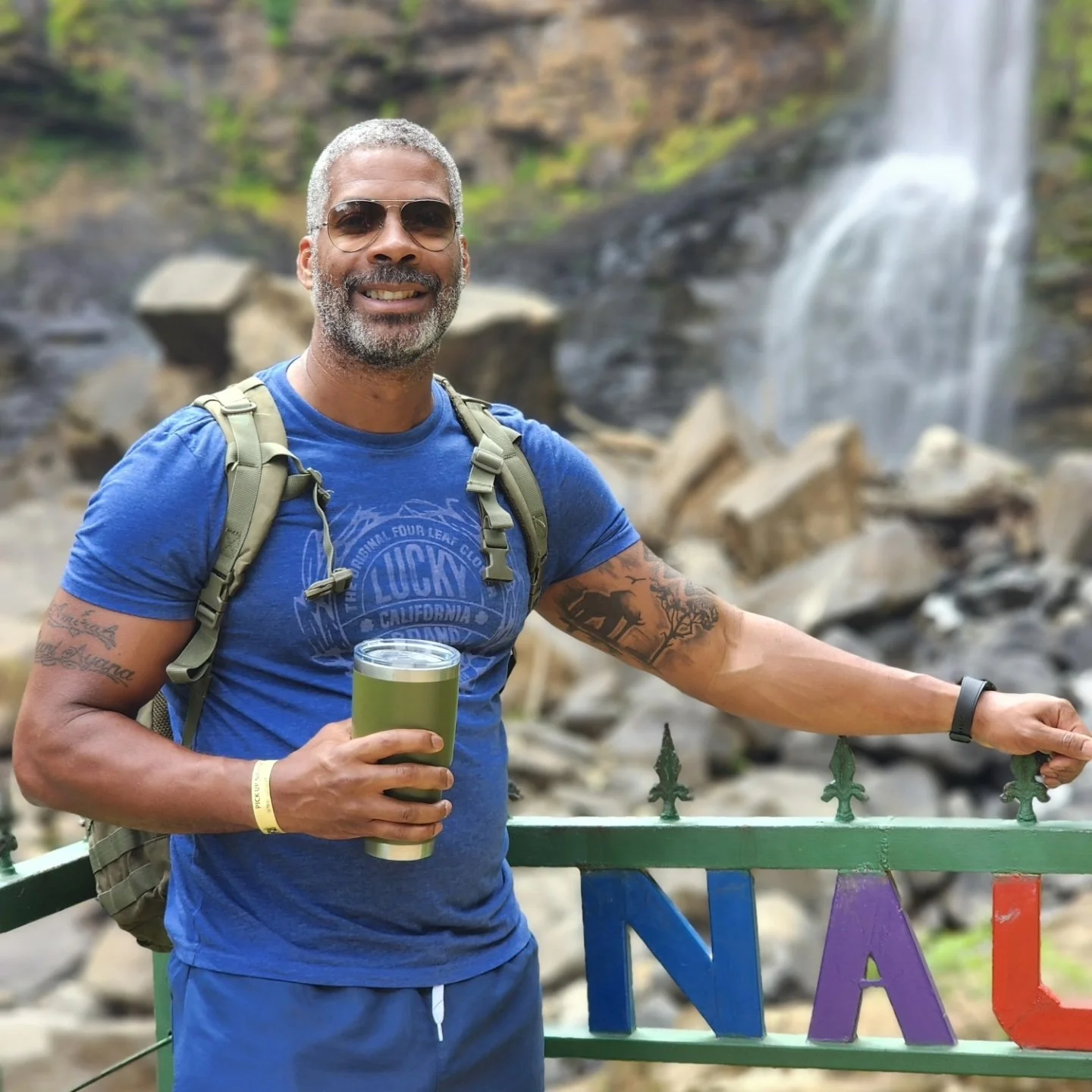 Male Registered Nurse in front of a waterfall