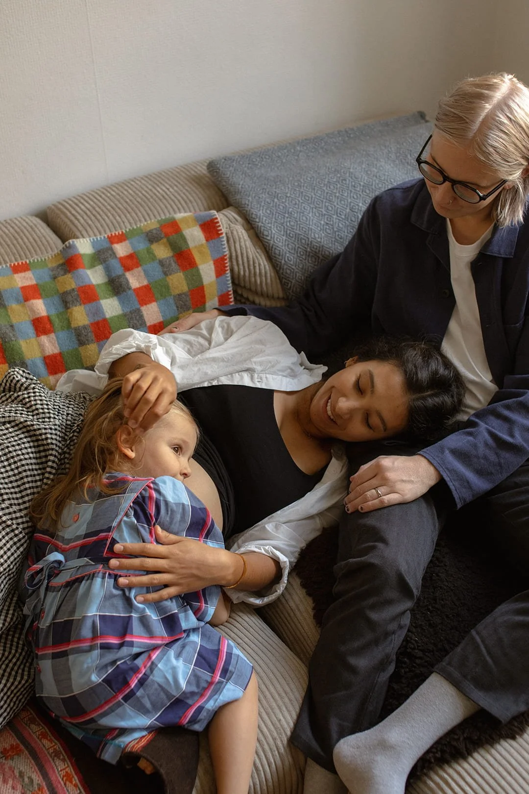 Pregnant woman with her partner and daughter during an in-home maternity photoshoot in Malmö
