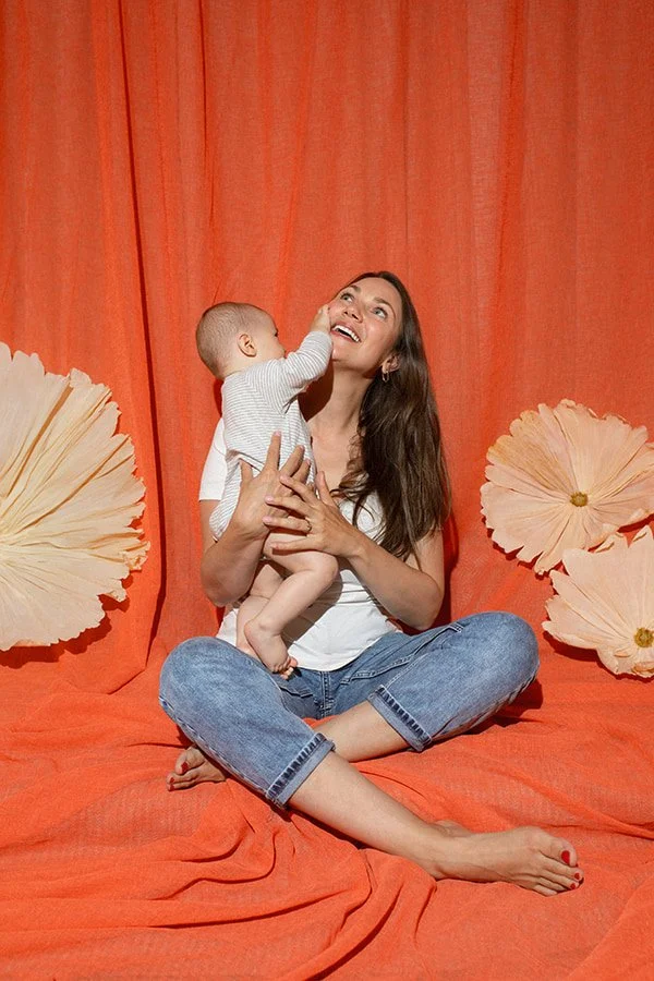 Close-up of mother holding her baby during an intimate motherhood photography session in Malmö. Natural family portrait capturing connection and tenderness for Mors Dag memories.