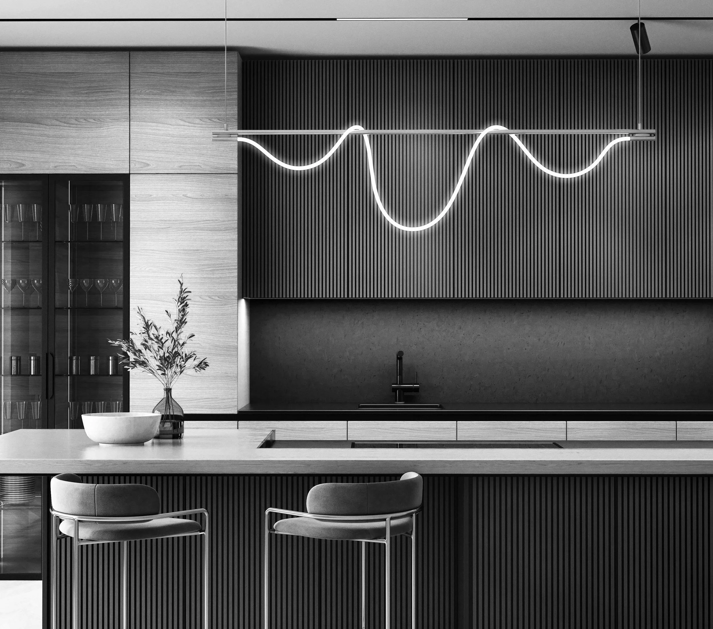 Modern kitchen with minimalist design featuring a black wavy line pendant light, a potted plant in a white bowl, and two upholstered chairs at a kitchen island.