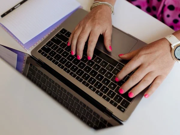 hands on a laptop keypad