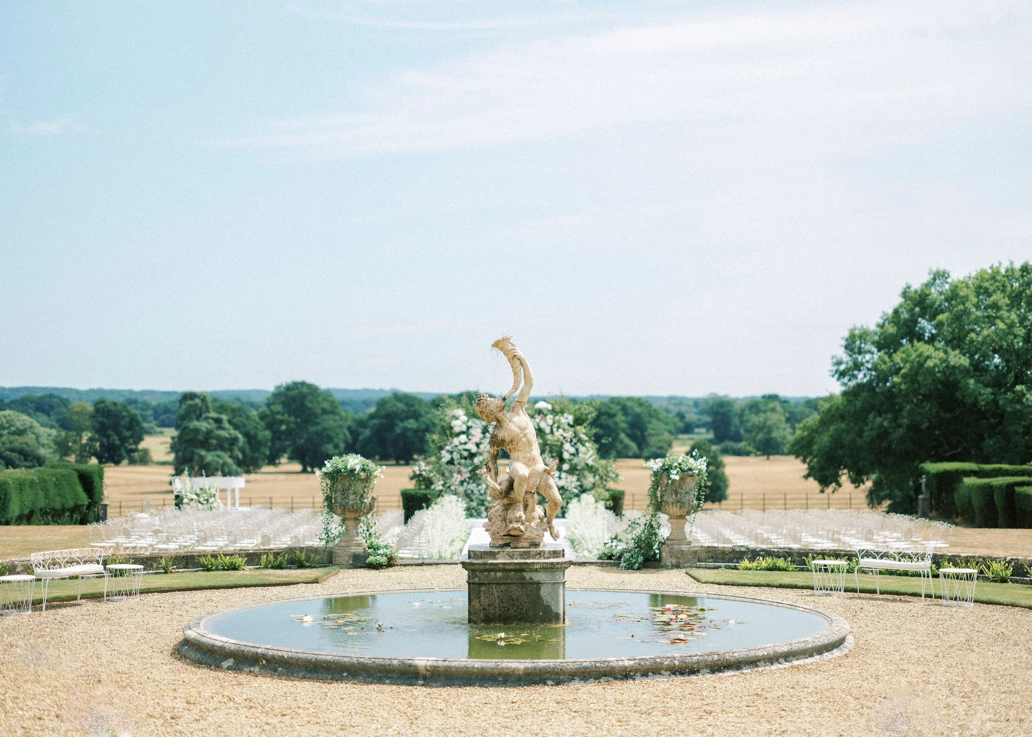 wedding ceremony set around garden fountain