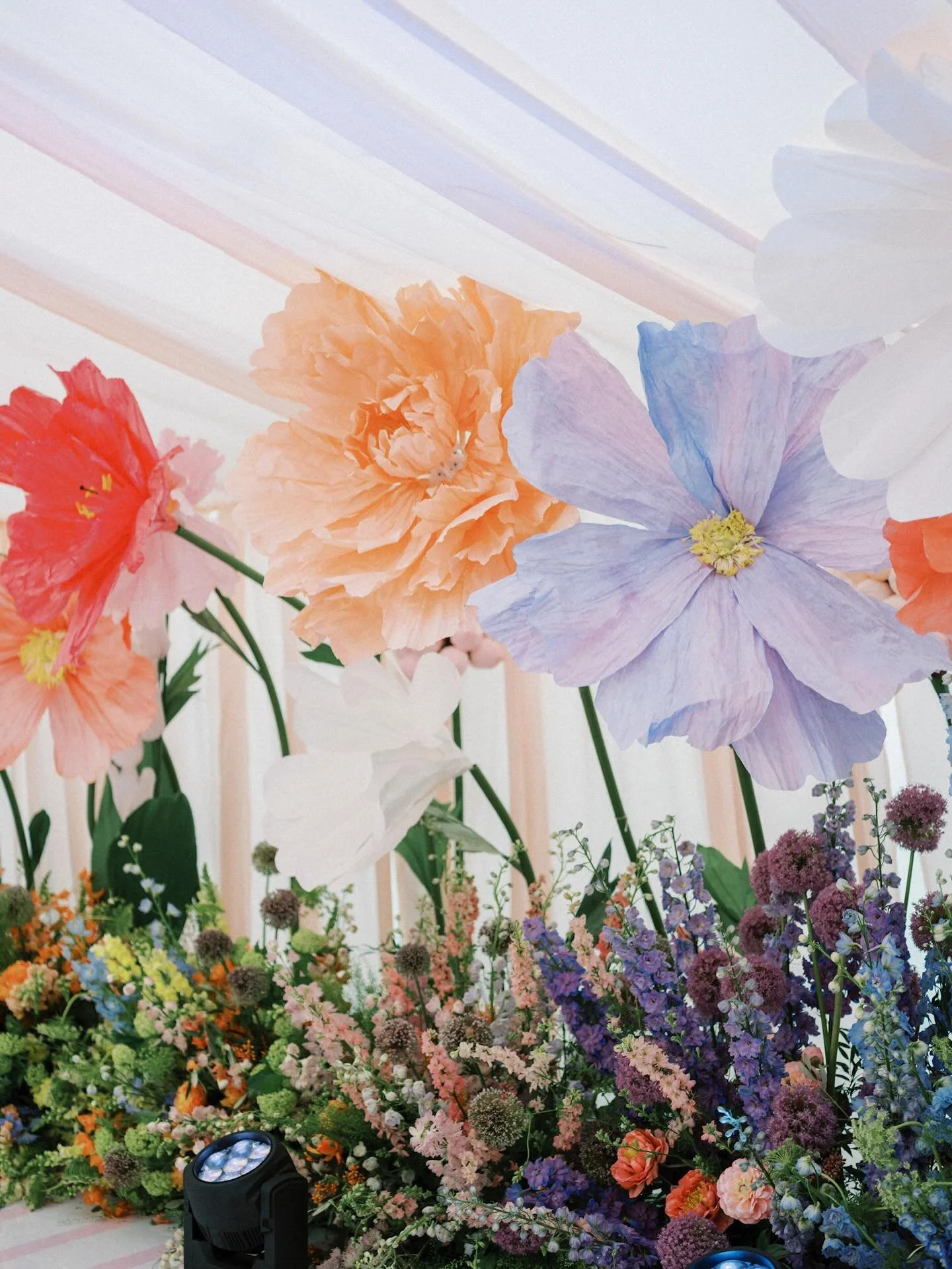 MEHNDI NIGHT // An evening designed to surprise and delight, inspired by Wes Andersen, where towering paper florals didn&rsquo;t simply style the setting but came to life, whimsically opening and closing throughout the marquee, like something from a 
