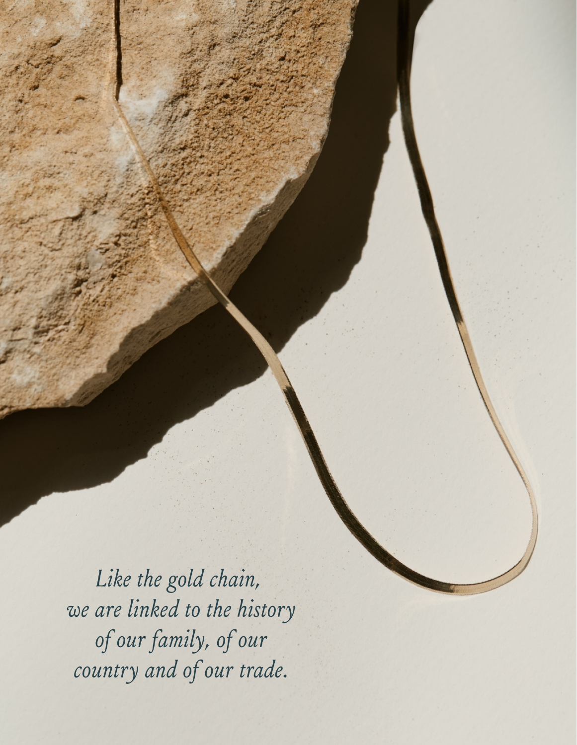 Gold chain laying on rock photo art direction by LETTER A