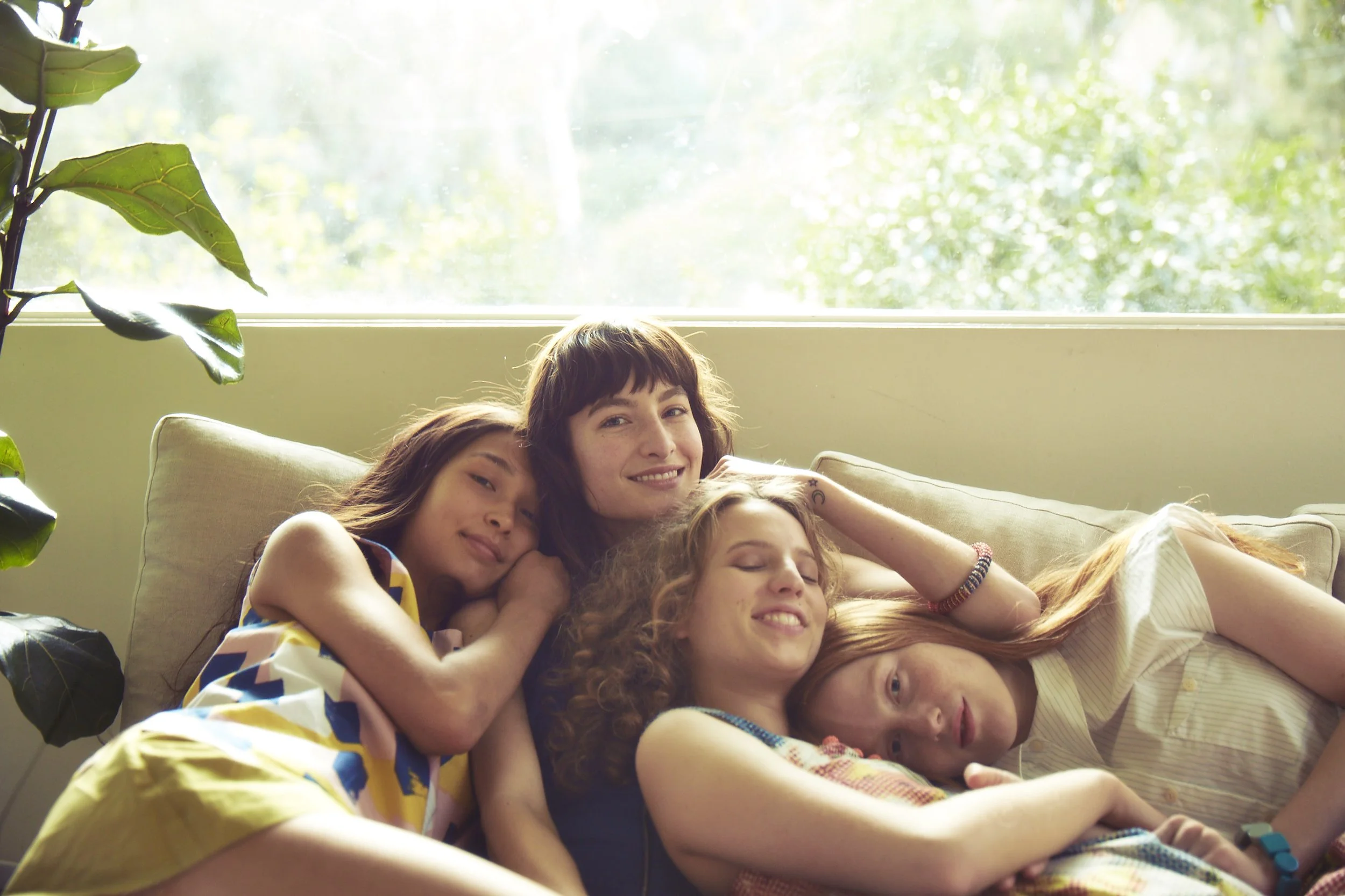 Four girls on a couch for Kate Spade Saturday led by Allison Henry Aver