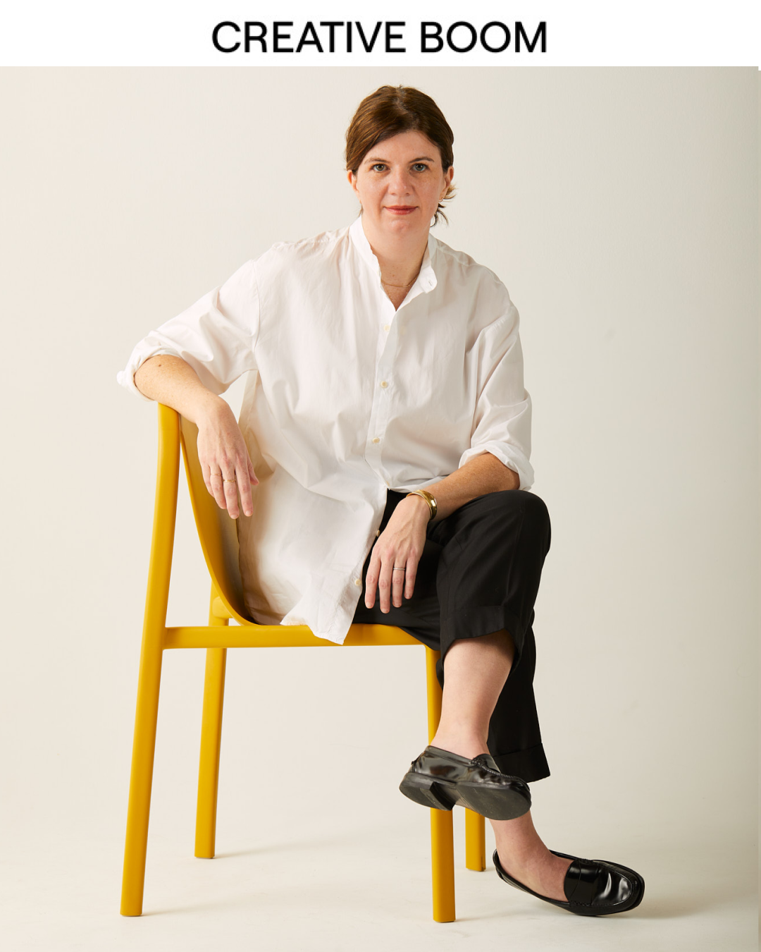 Photo of Allison Henry Aver on a yellow chair