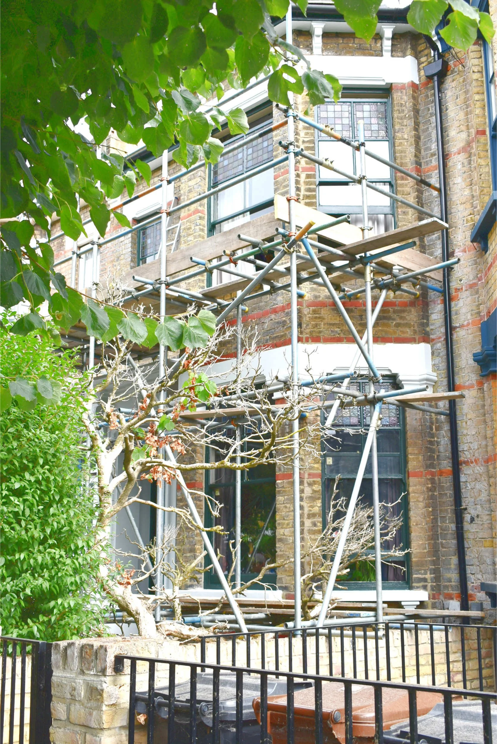 A Victorian House renovation in hackney with a view from the street showing scaffolding and works in progress