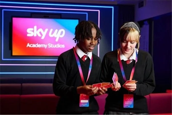 Two students looking at careers cards inside Sky Academy Studios