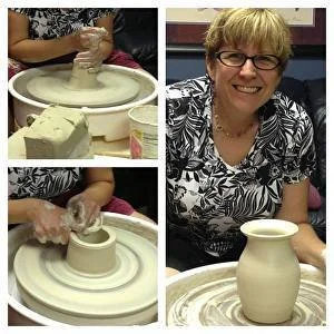A woman smiling at a pottery wheel with a clay vase she is shaping, actively working with her hands to mold the clay.