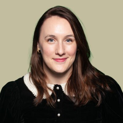 Amie Kashon smiling against a light green background.