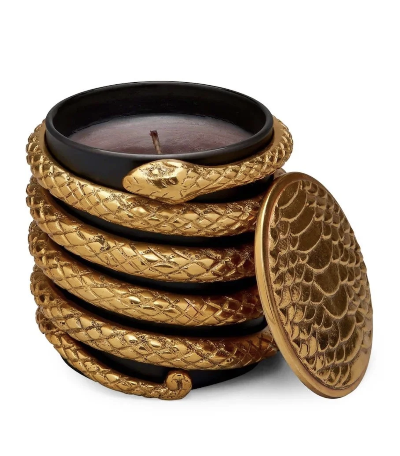 A decorative black and gold snake-themed tea light holder with a lit candle inside, shaped like a coiled snake with intricately patterned gold scales.