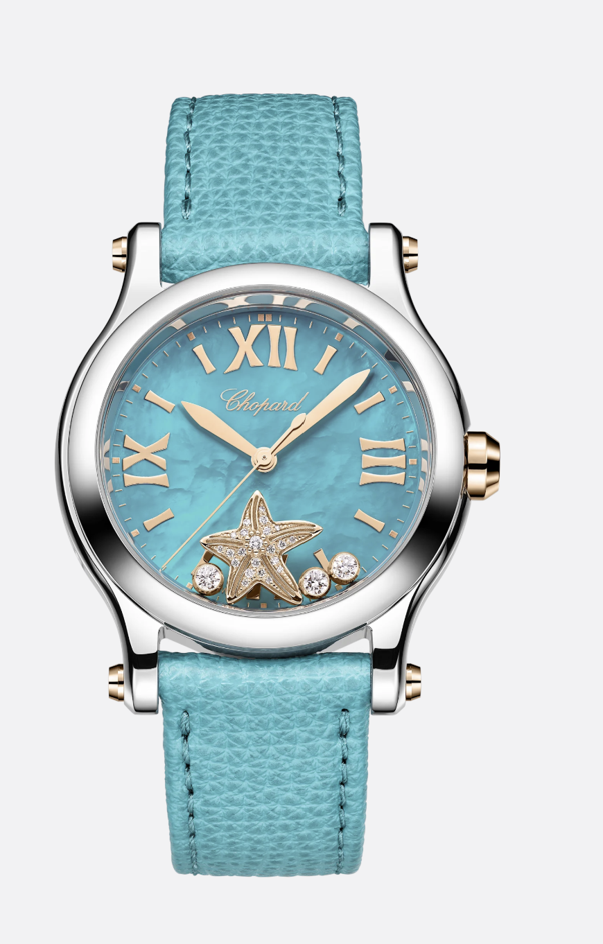 A luxury wristwatch with a blue face, gold Roman numerals, and a starfish decoration with embedded diamonds, paired with a textured blue strap.