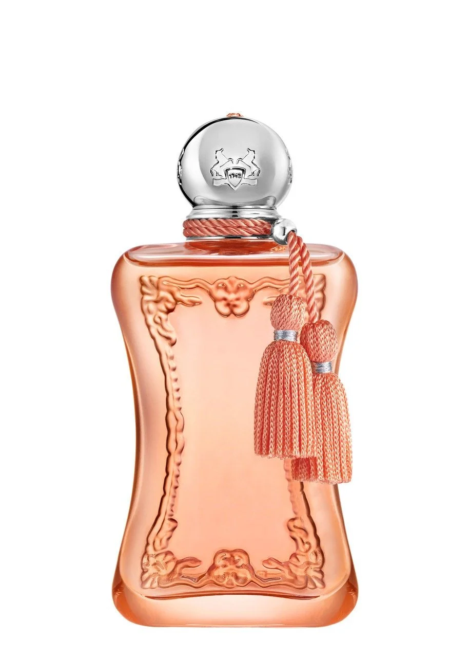 A vintage-style perfume bottle with ornate detailing and a silver cap, decorated with a pink tassel.