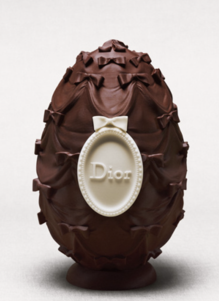 Chocolate Easter egg with decorative bows and a white Dior tag.