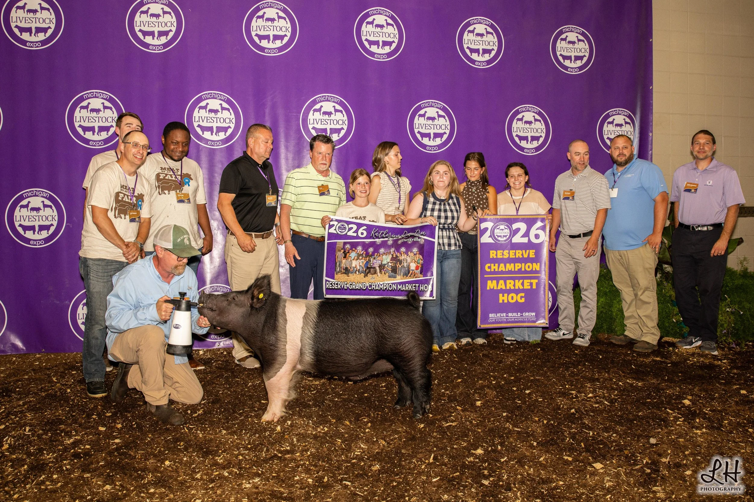Saleabration backdrop photo with Katerine Rowntree, buyers and Reserve Grand Champion Market Hog 2026