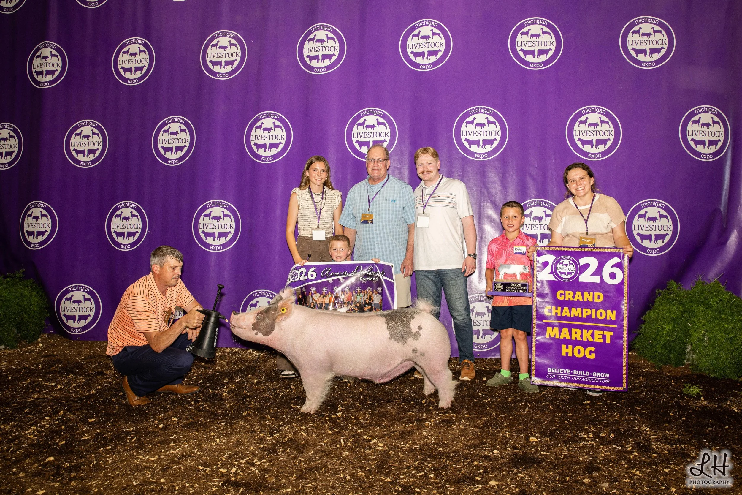 Saleabration backdrop photo with Anna Dahms, Buyers and Grand Champion Market Hog 2026