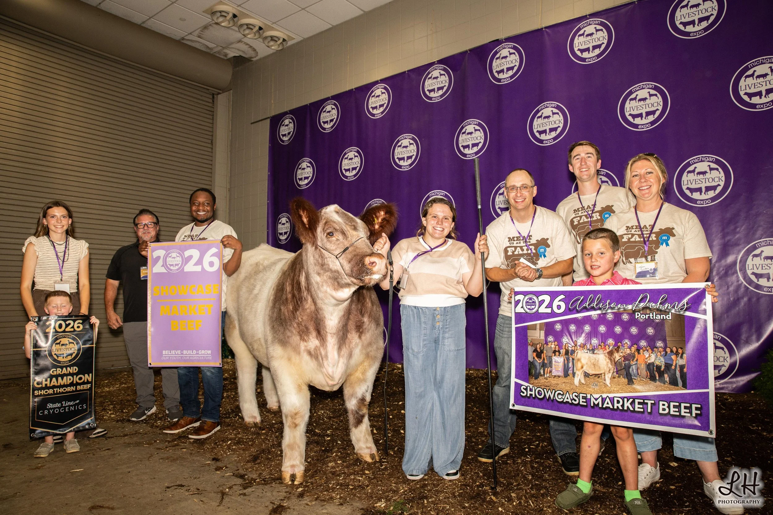 Addison Dahms at Sale-a-bration backdrop with Showcase Market Beef and Buyers