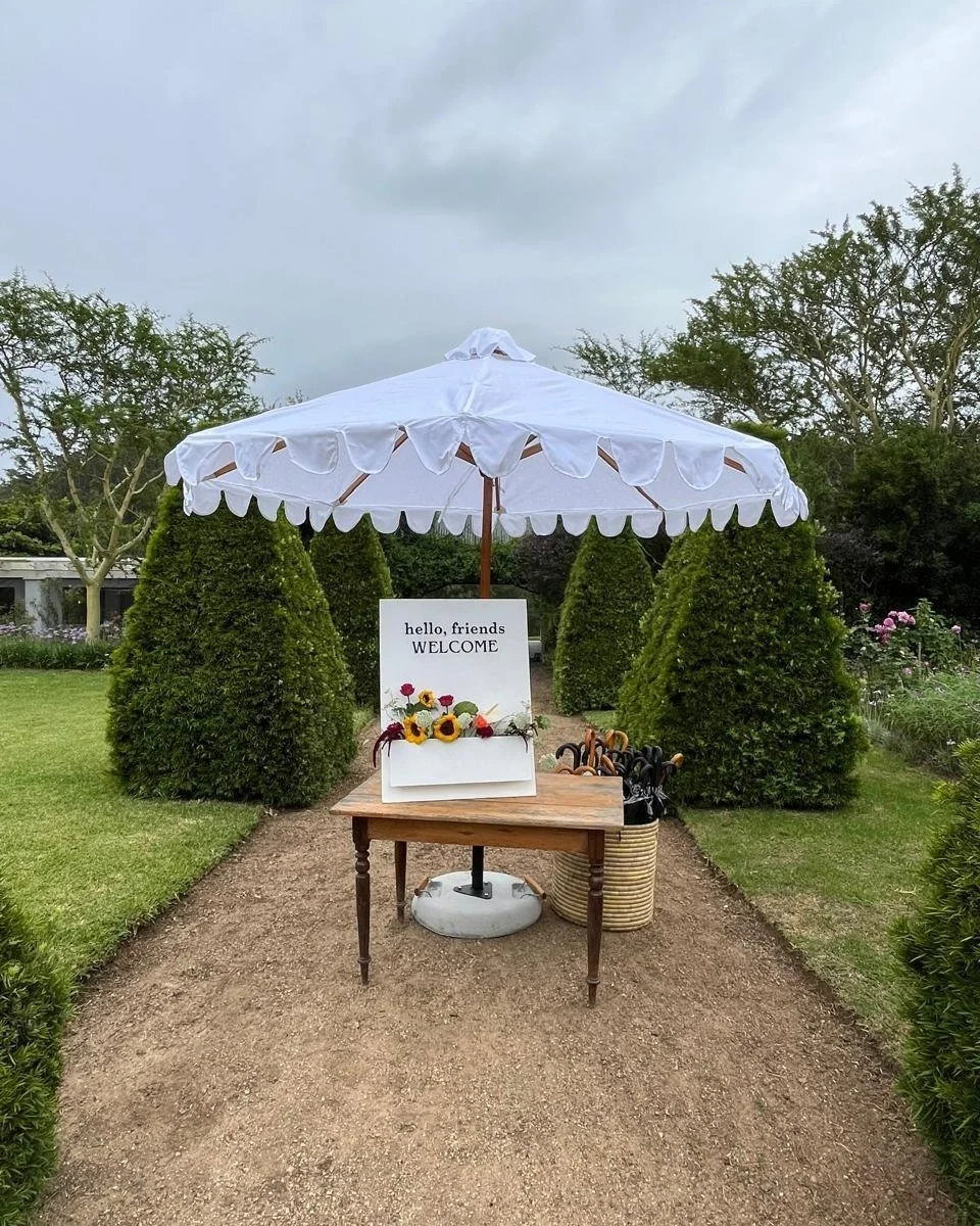 A little product feature today &mdash; our White Scallop Umbrellas.

Pretty, elegant, and they honestly go with anything.

Beach wedding? Absolutely.
Cocktails in the Rose Garden? Say no more.
Keeping the barmen &amp; drinks cool? They&rsquo;ve got y