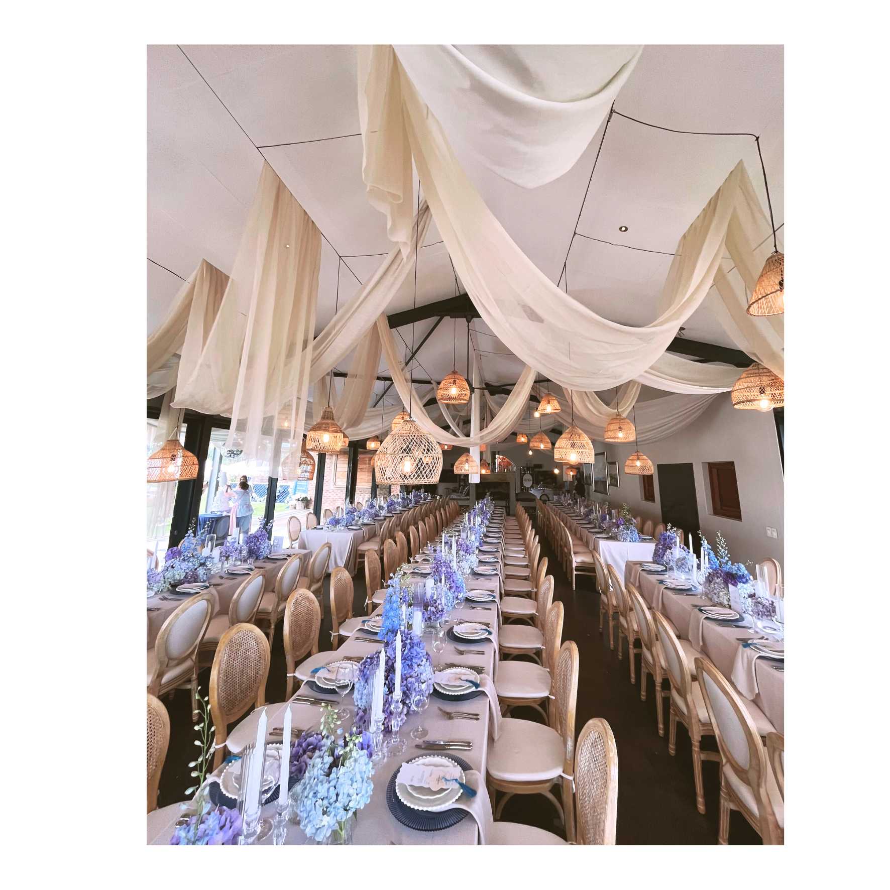 Wedding draping with louis chairs, olivia upholstered chairs and naked bulbs with malawian baskets for wedding and corporate event hire by Du Toit Events in Plettenberg Bay and the Garden Route