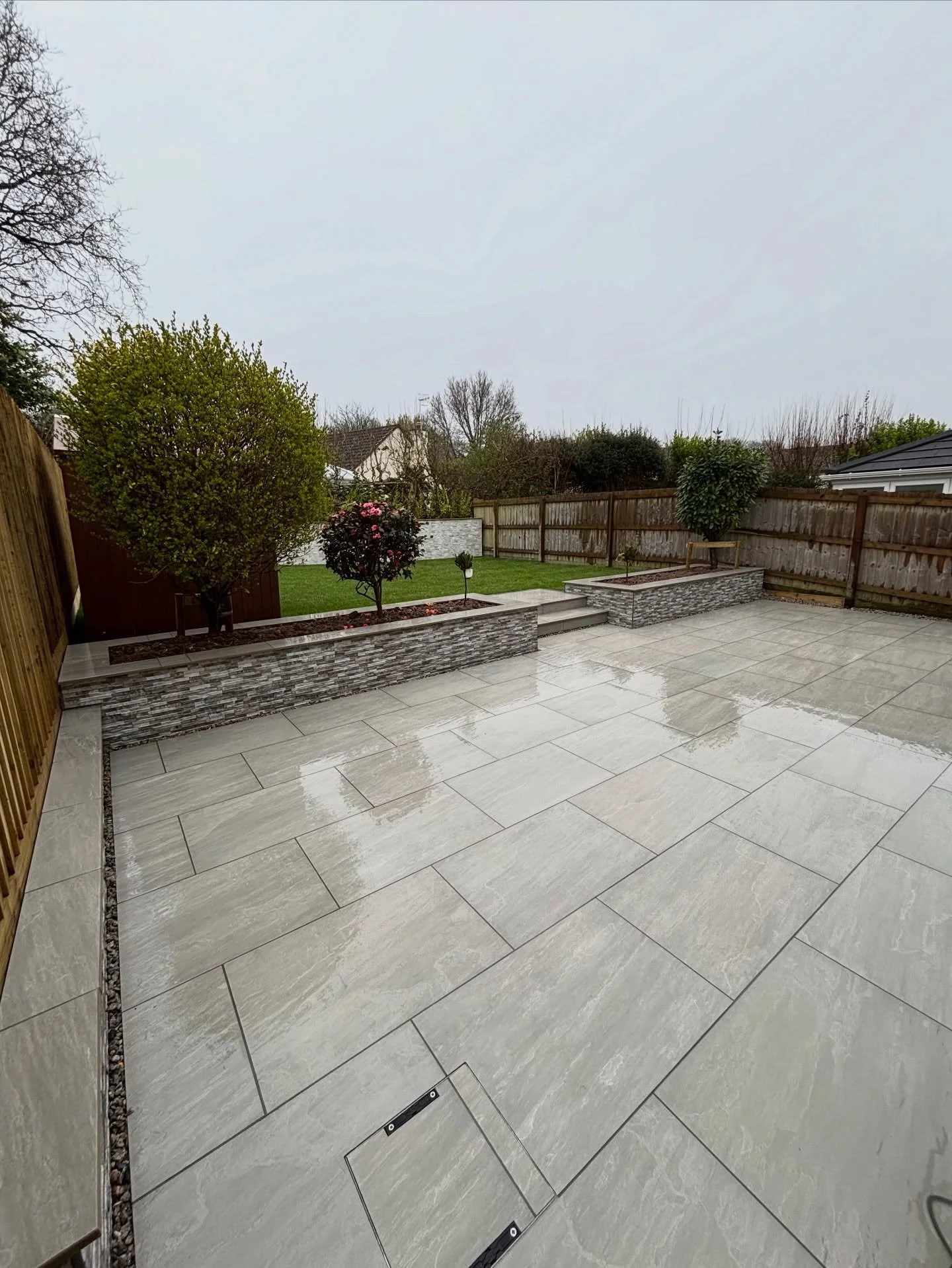 Project Woolms 🪨🩶 

Take a look at this collection of photographs! What a difference 😍 although the weather was consistently bad the whole job, we battled through and delivered anyway 🤝☔️

The kandla grey porcelain from @nustone_uk 🤌💙

#landsca