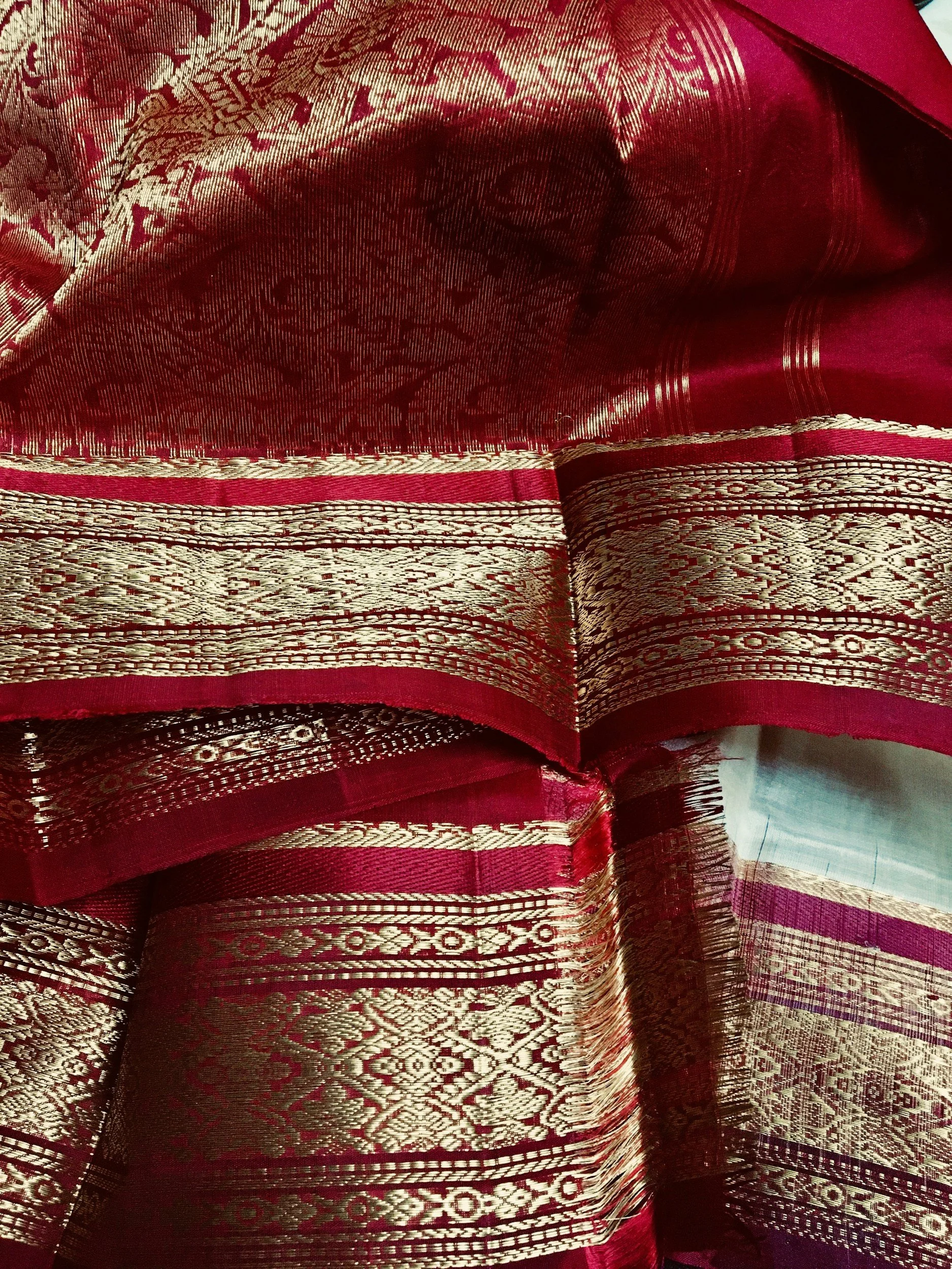Gold thread border on a red sari