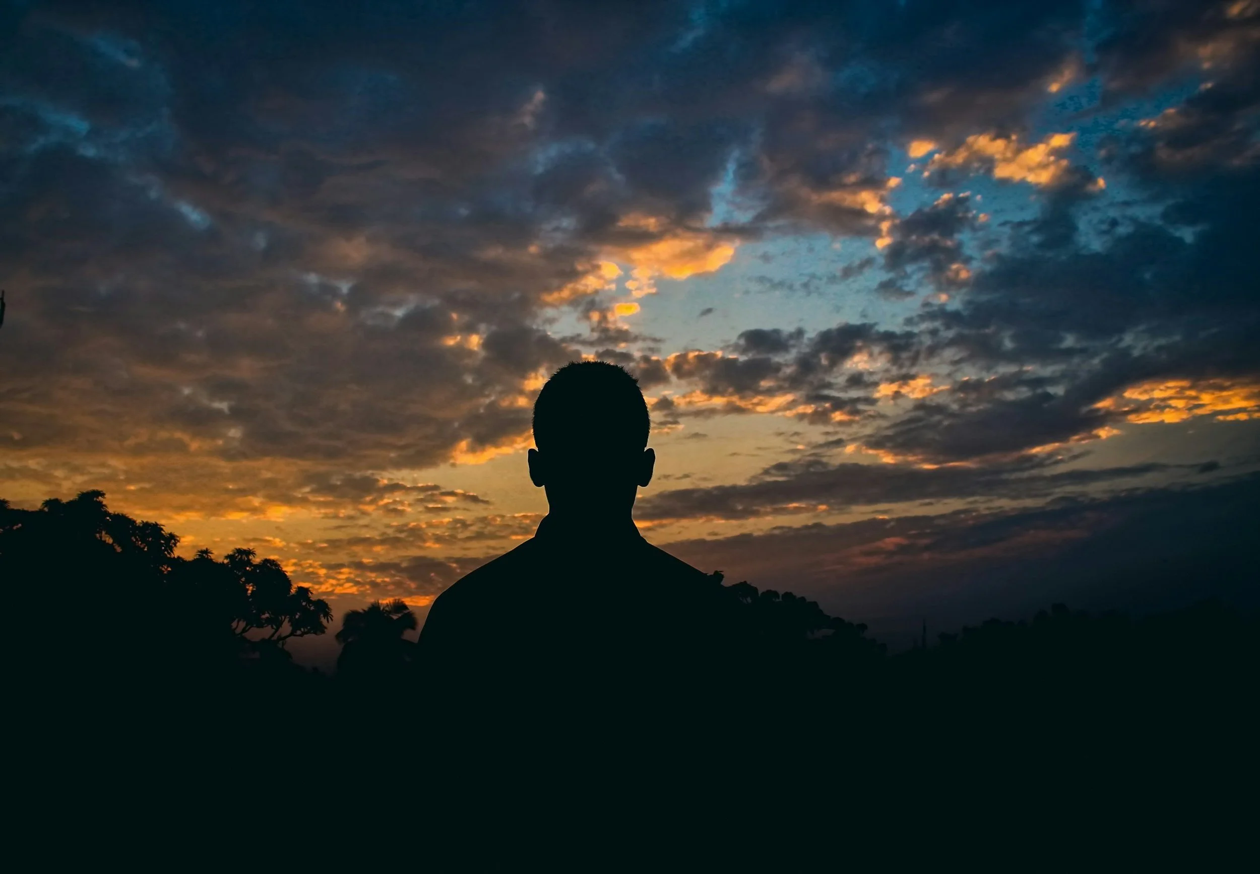man alone looking at evening sky