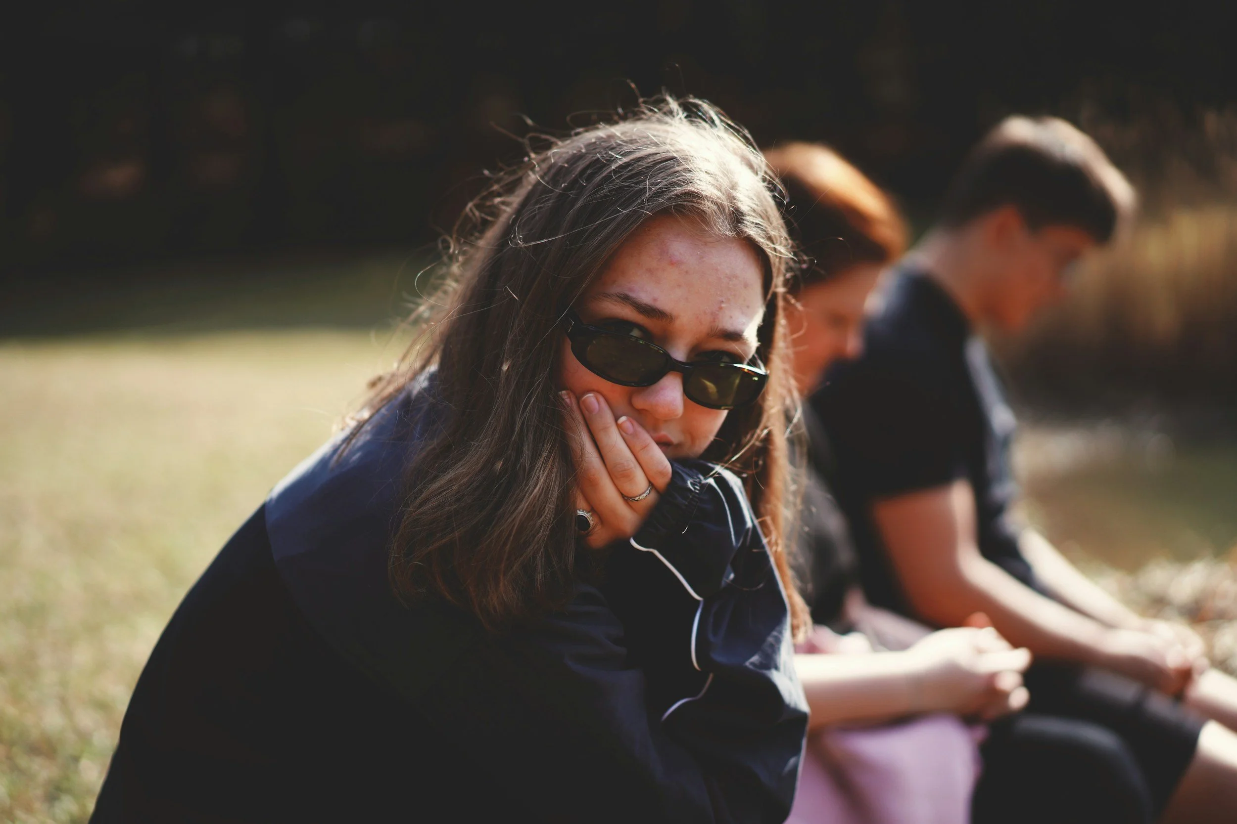 women sitting away from friends due to social anxiety