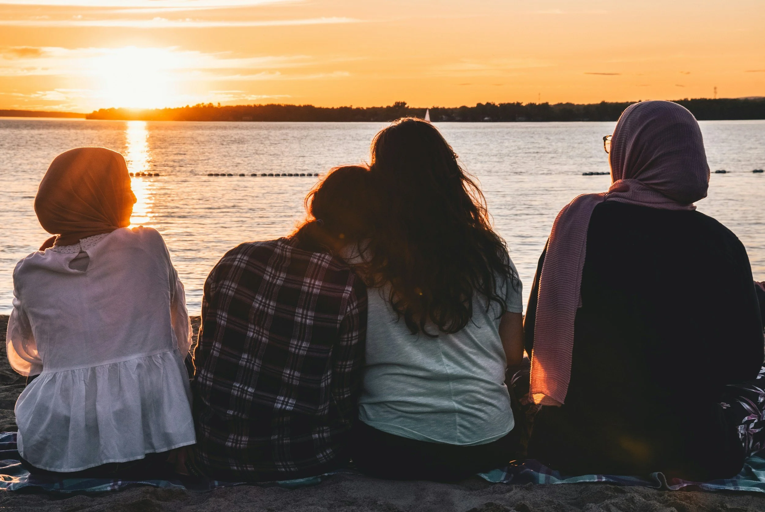 group of friends watching a sunset