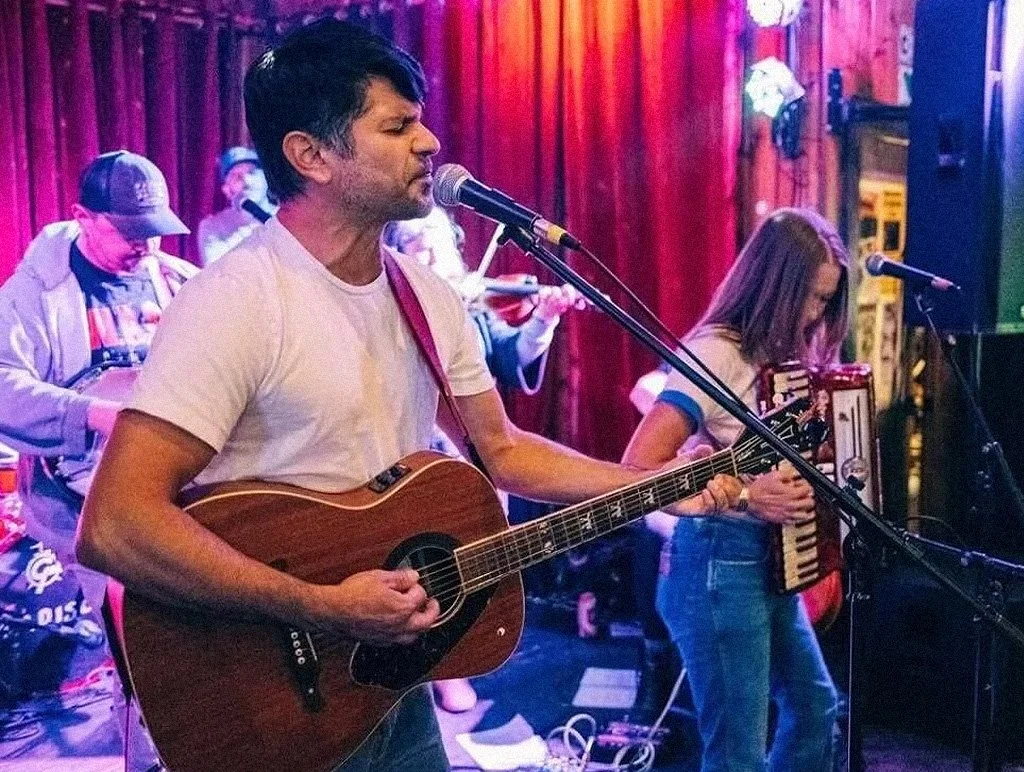Image of older male playing guitar