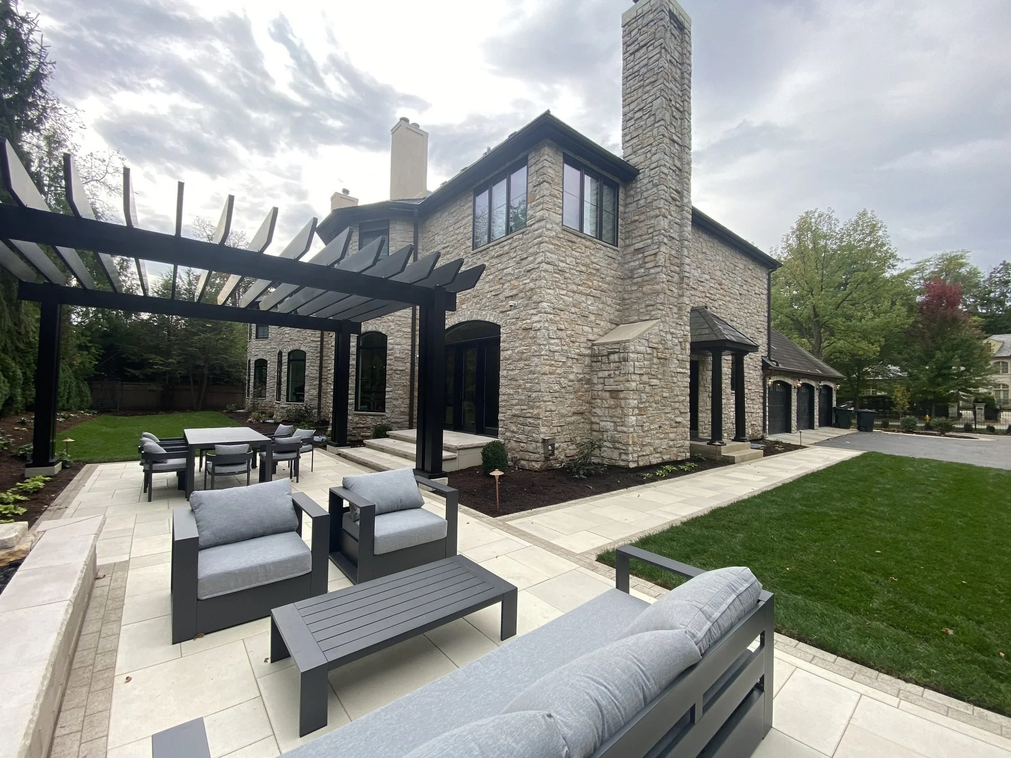 Custom stone and shingle home with a covered entry, built by Direct Homes