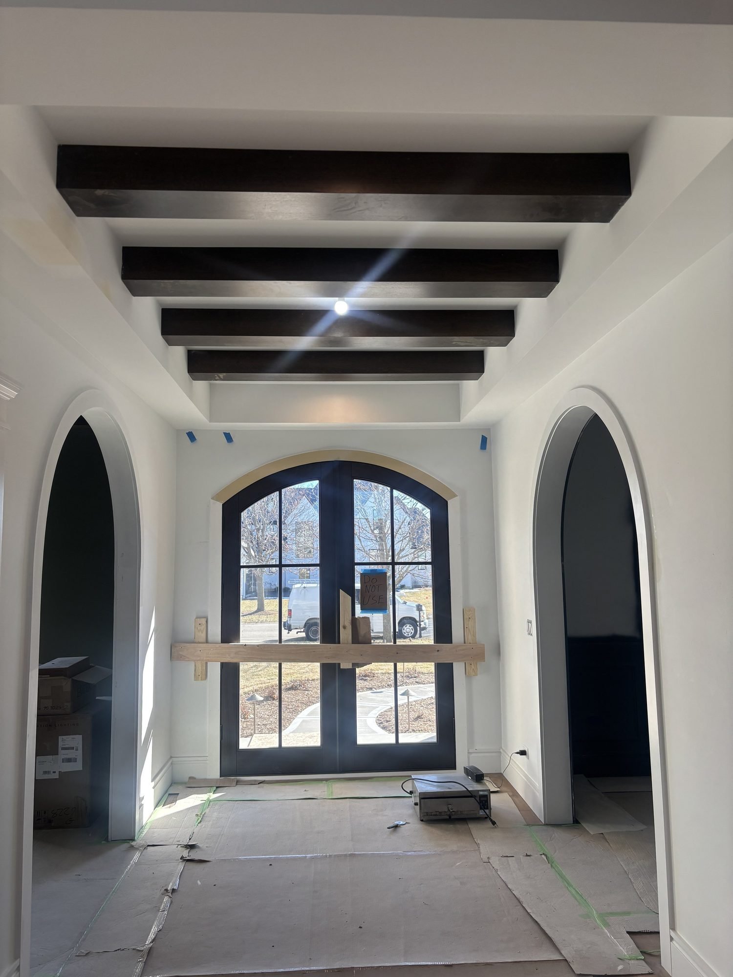 Interior foyer with exposed wood beams in a Direct Homes custom home