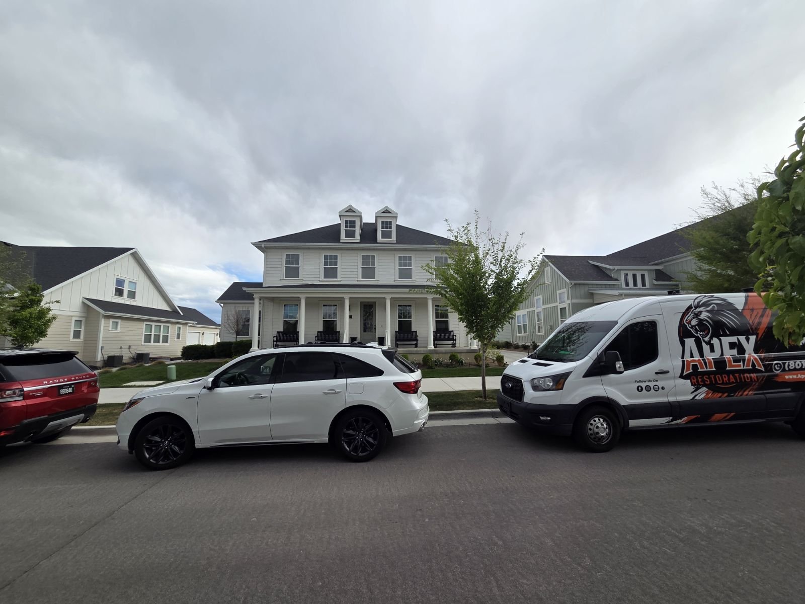 Apex Restoration service van in a Utah neighborhood
