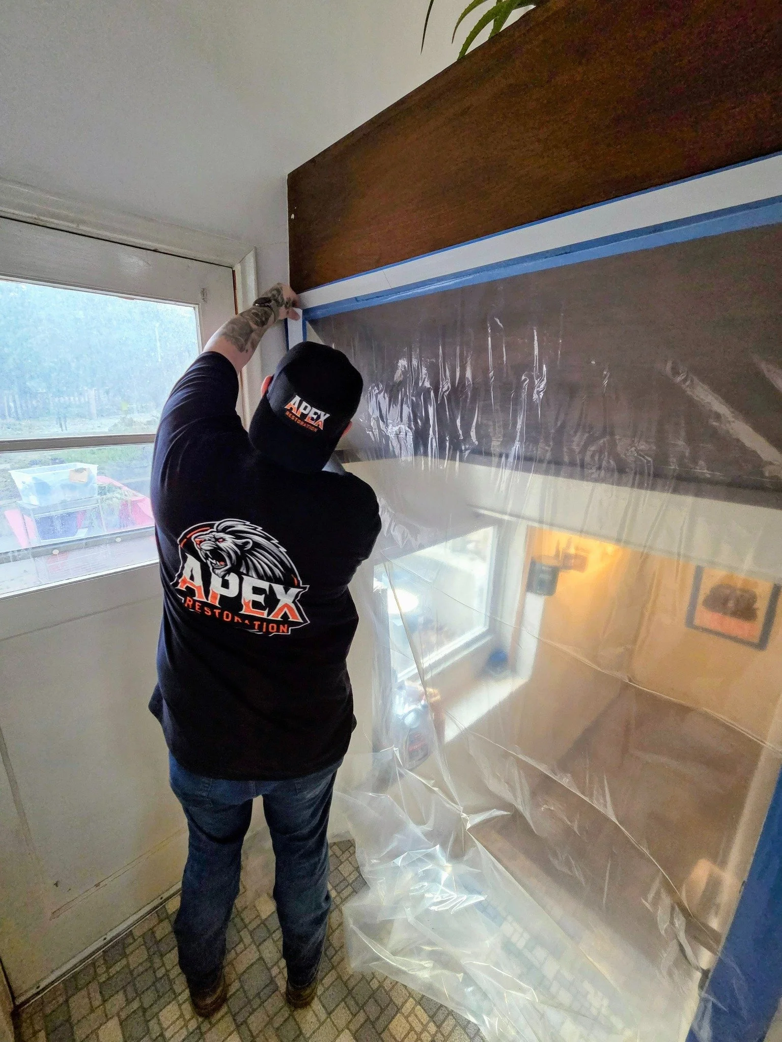 Apex Restoration technician installing plastic containment during a restoration project in Millcreek, Utah